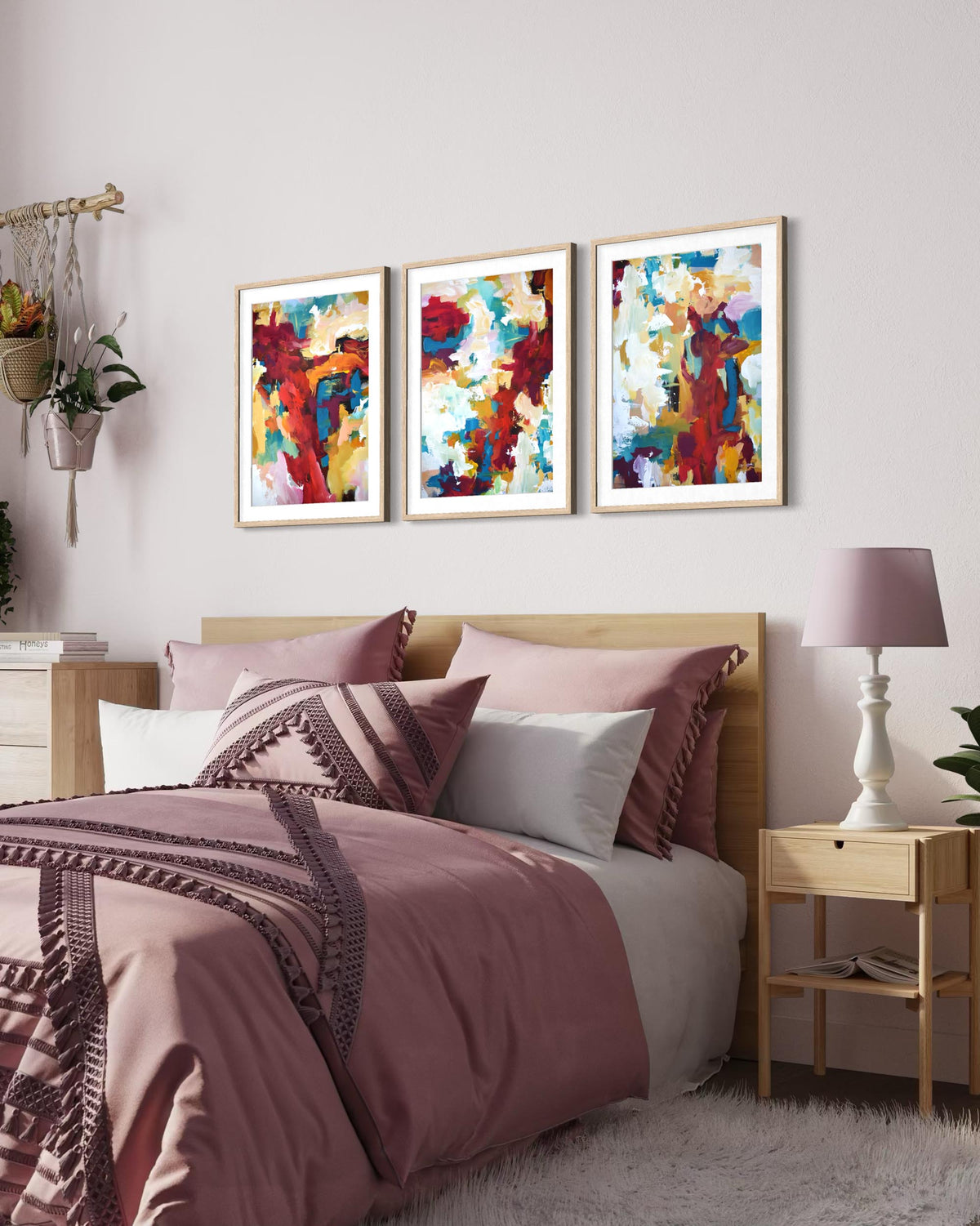 Large set of 3 red abstract art prints on a wall in a bedroom