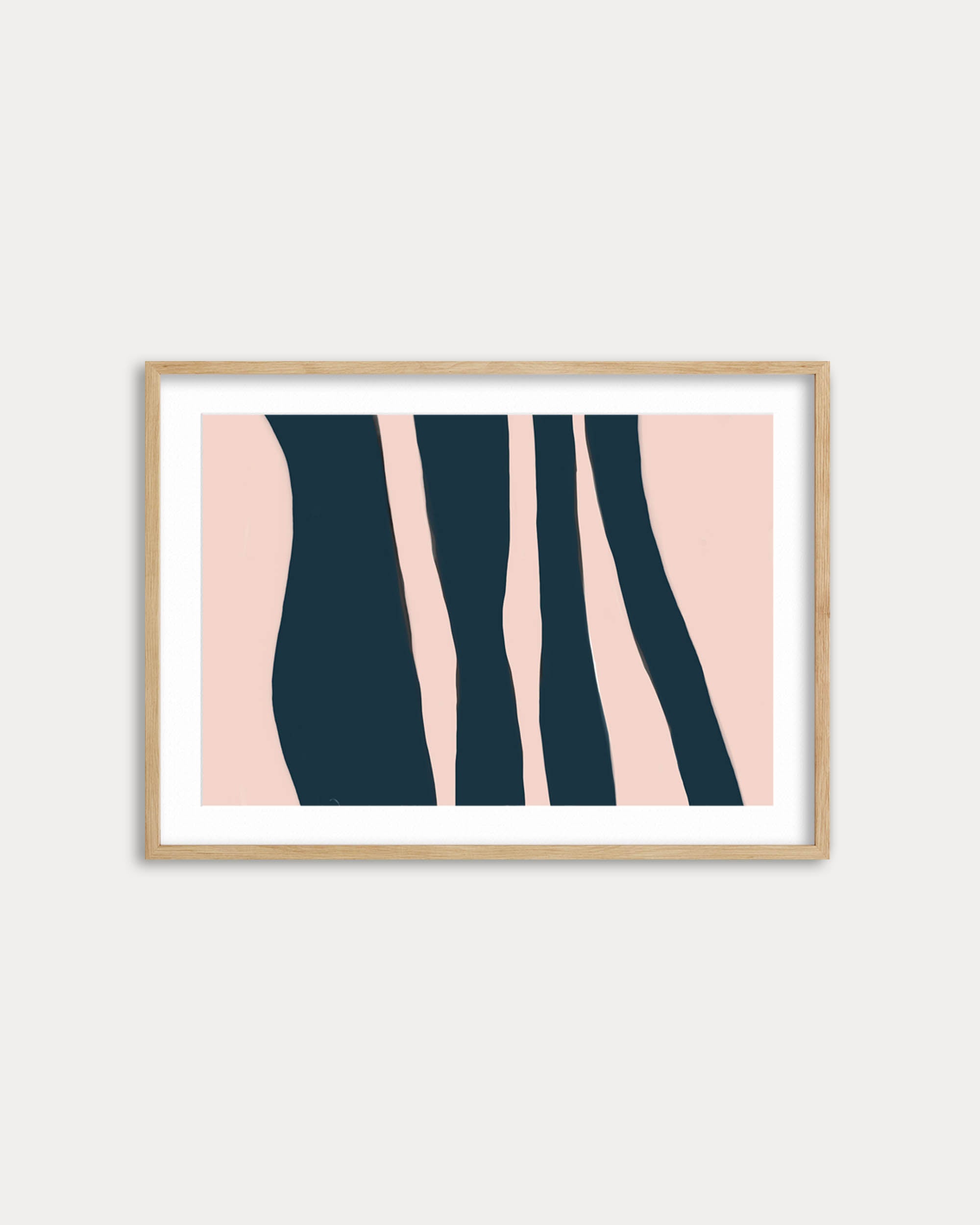Framed abstract art print with pink and navy design on a white wall