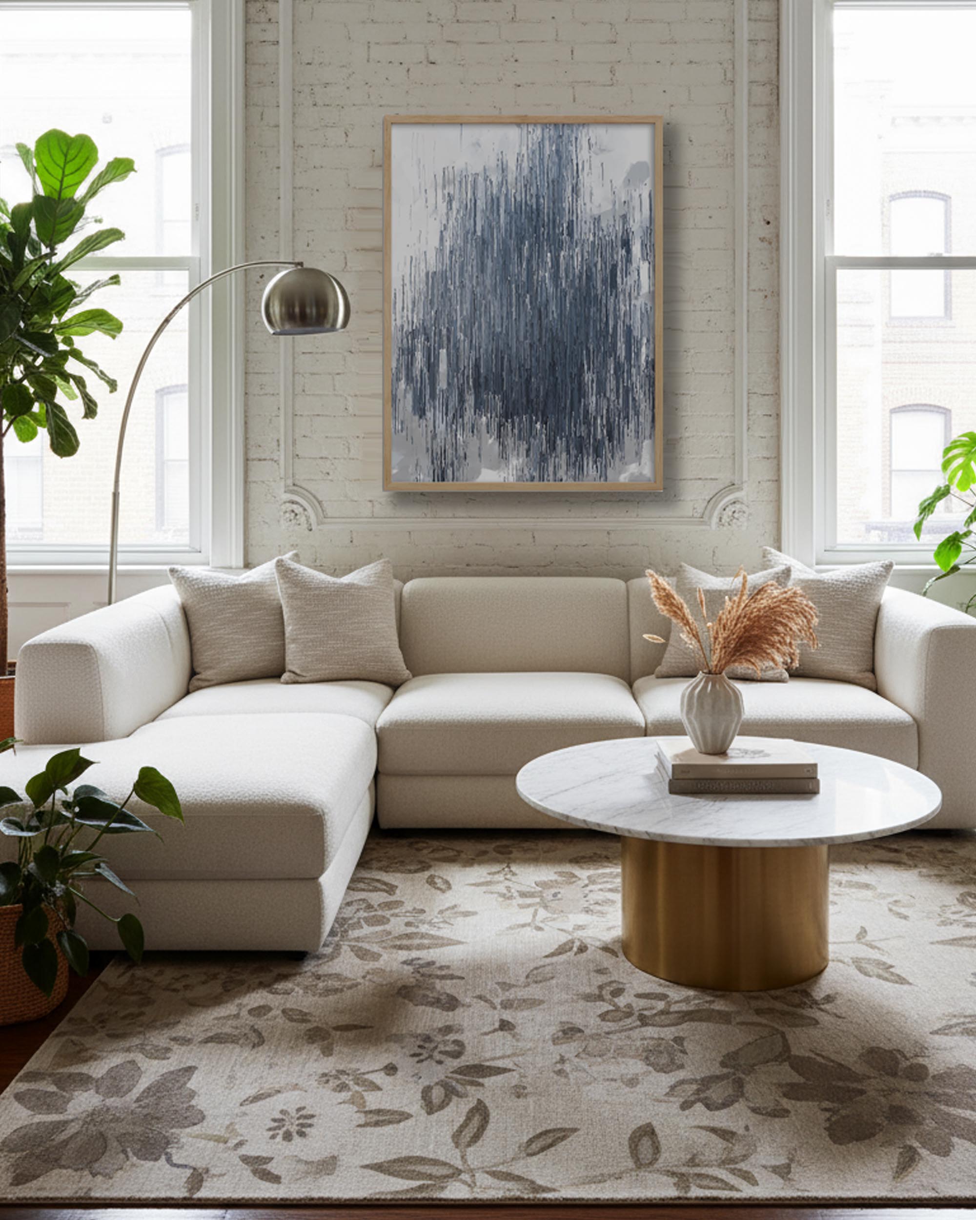 Modern living room with a beige sectional sofa, round coffee table, and abstract art on the wall.
