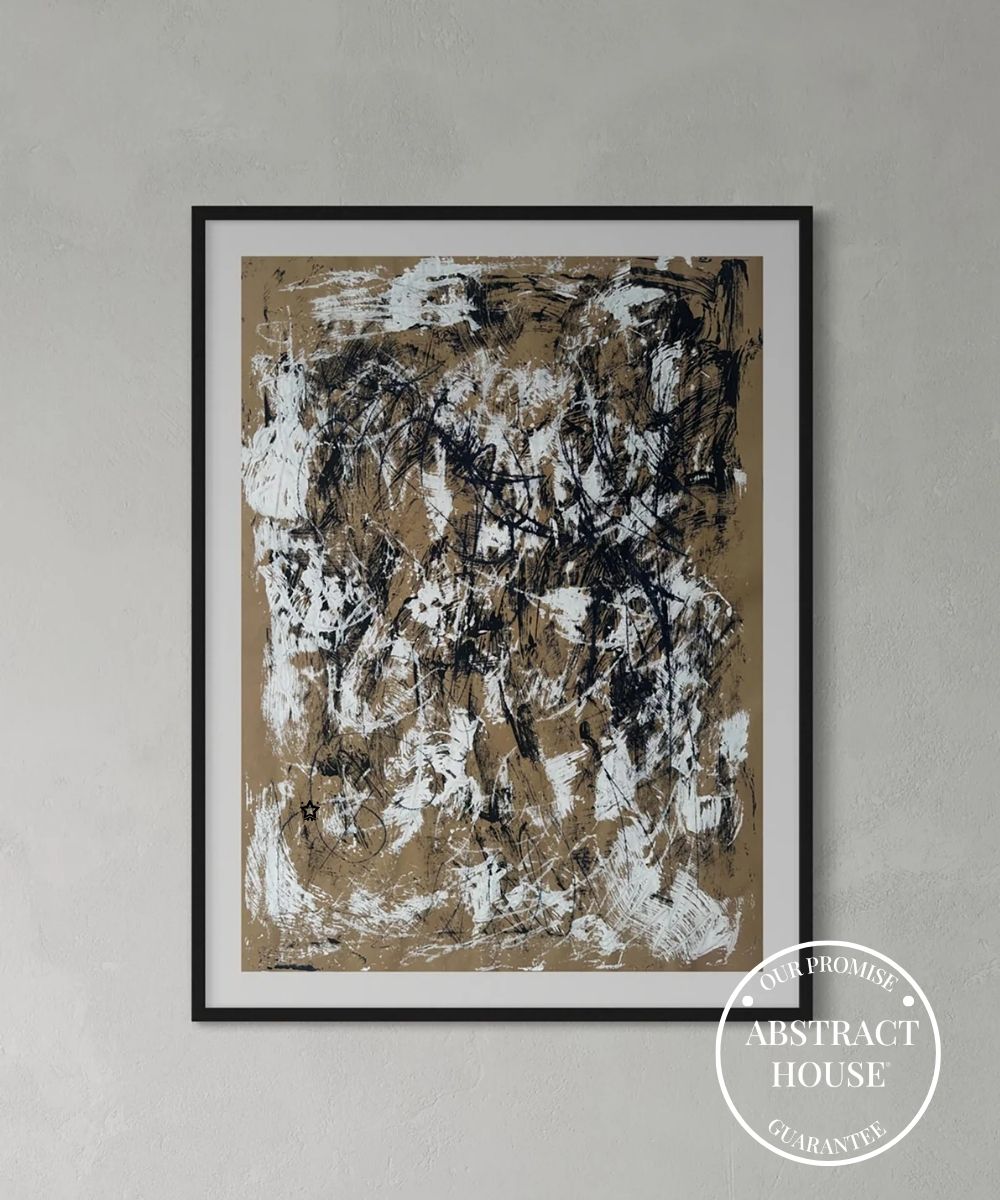 Original abstract painting with black and white brush strokes on a beige background, framed and hanging on a grey wall.