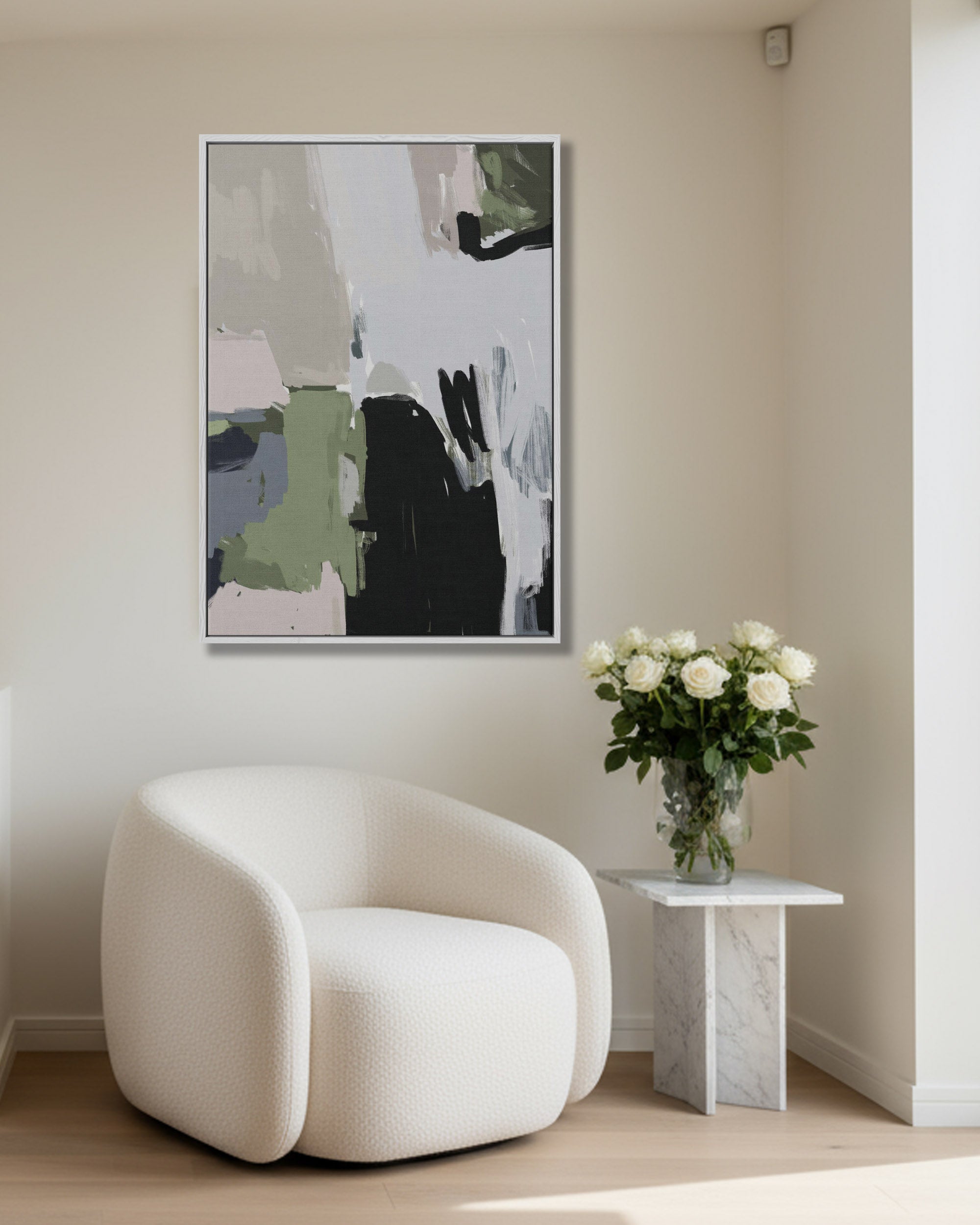 Modern interior with a white armchair, abstract art on the wall, and a small table with flowers.