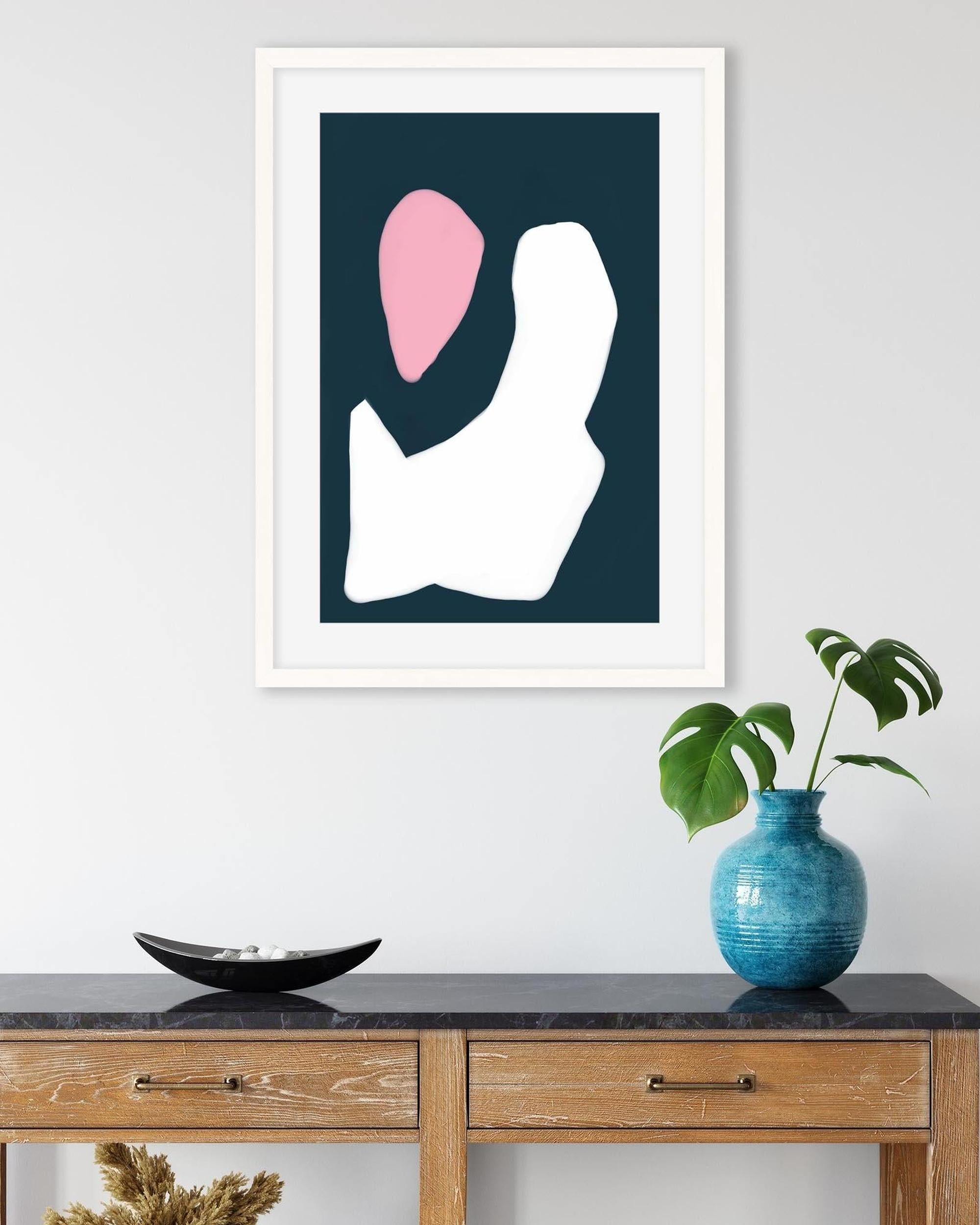 Framed abstract art piece on a wall above a wooden console table with decorative items.