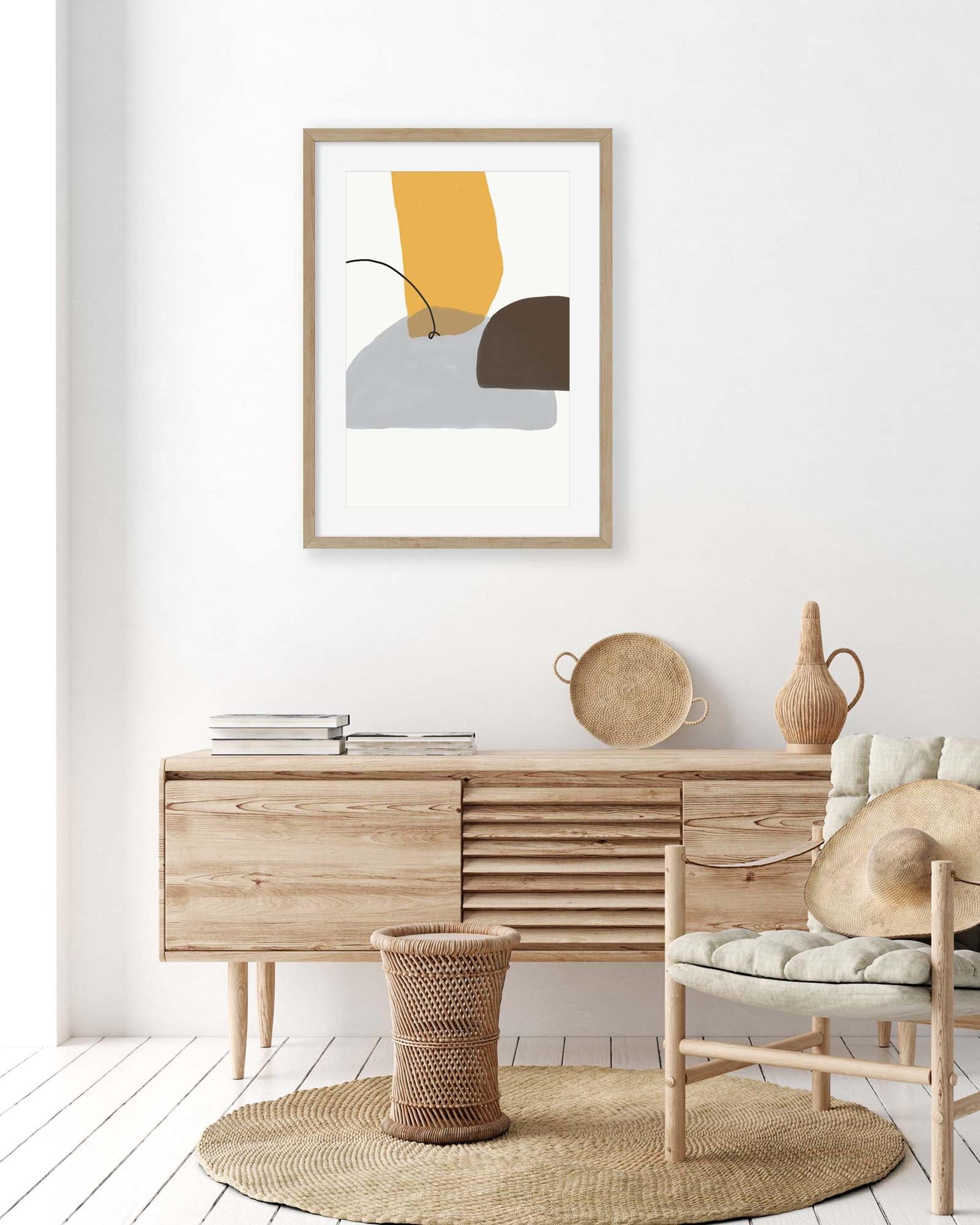 Modern interior with wooden sideboard, chair, and abstract art on white wall