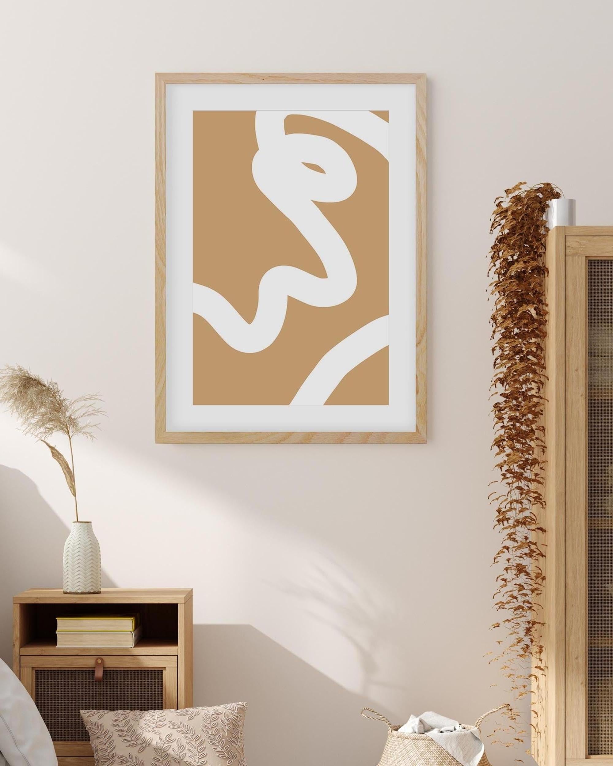 Abstract art print in a wooden frame on a wall with decorative elements.