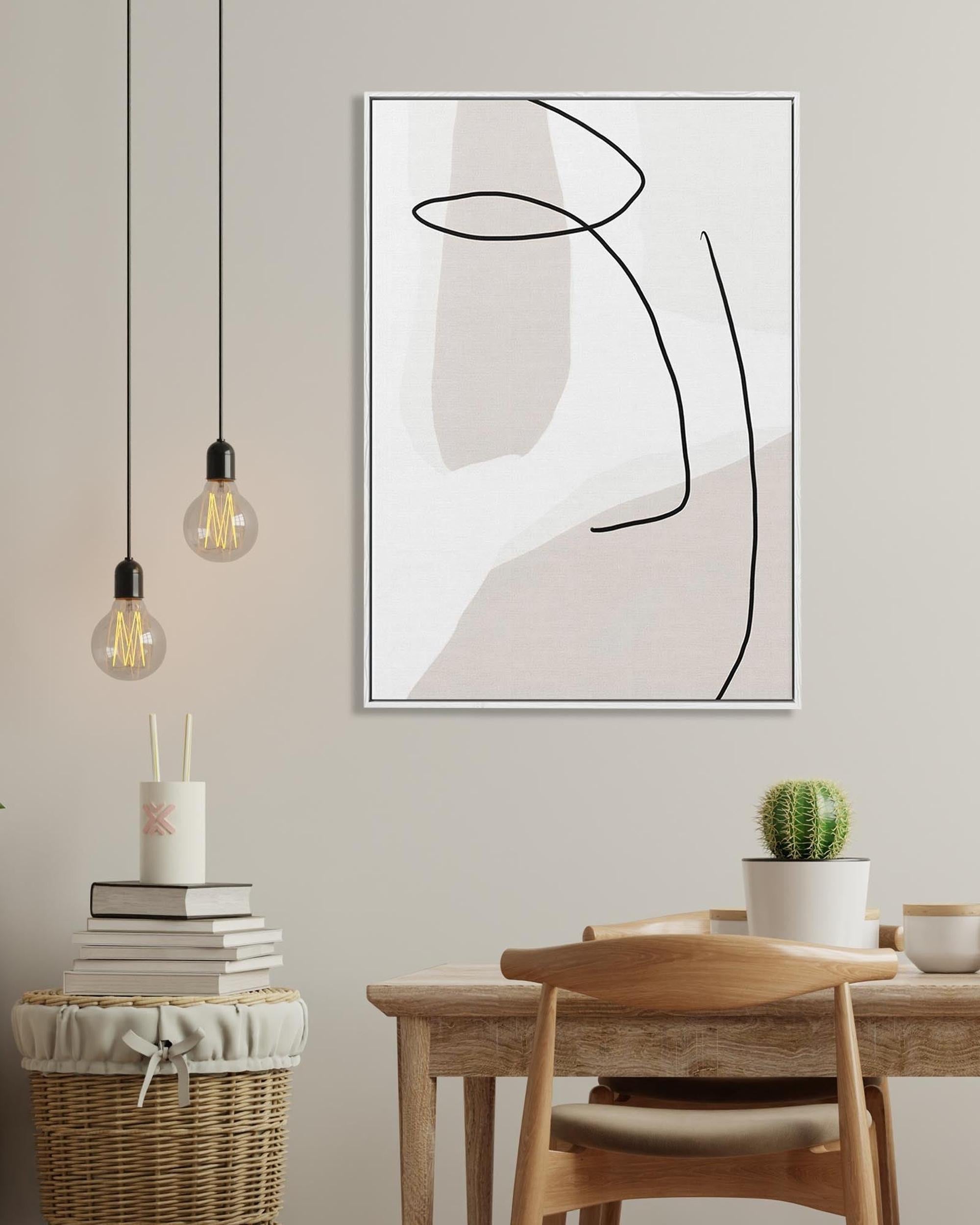 Abstract art print on a wall above a dining table with decor items.