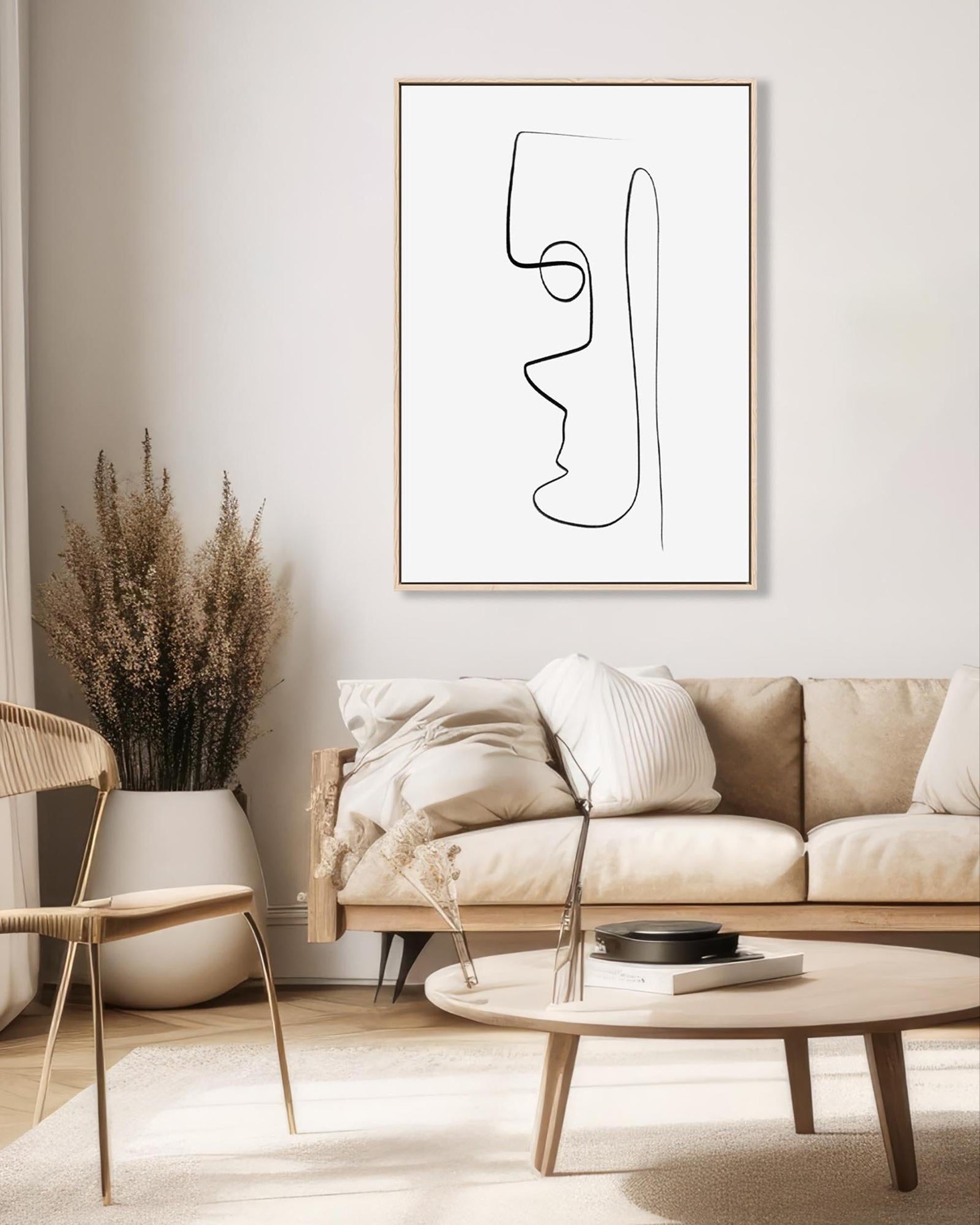 Modern living room with abstract art, sofa, and decor items.