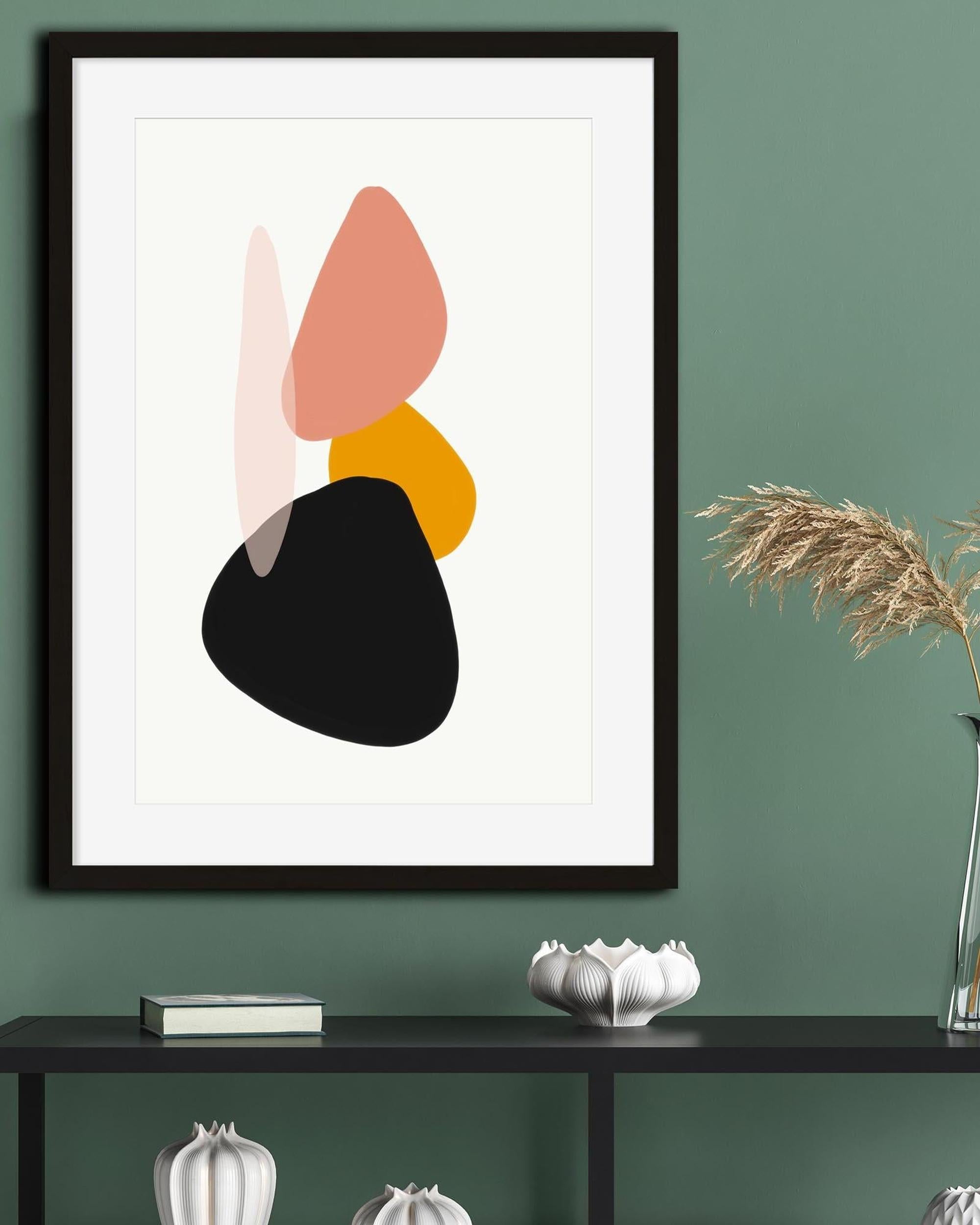 Framed abstract art print with colorful shapes on a green wall above a black console table.