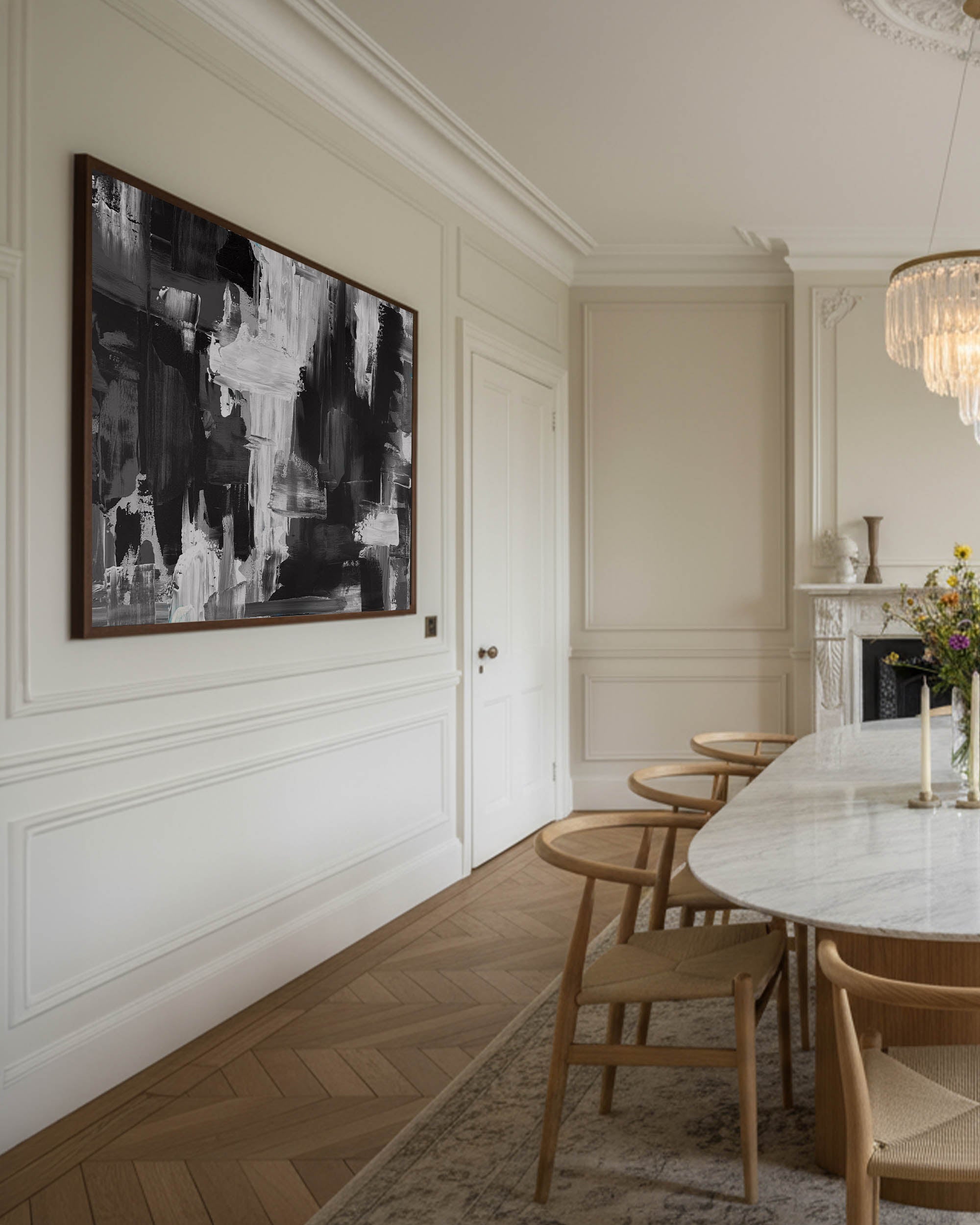 large black and white abstract wall art in modern Scandinavian dining room, beige walls with large chandelier