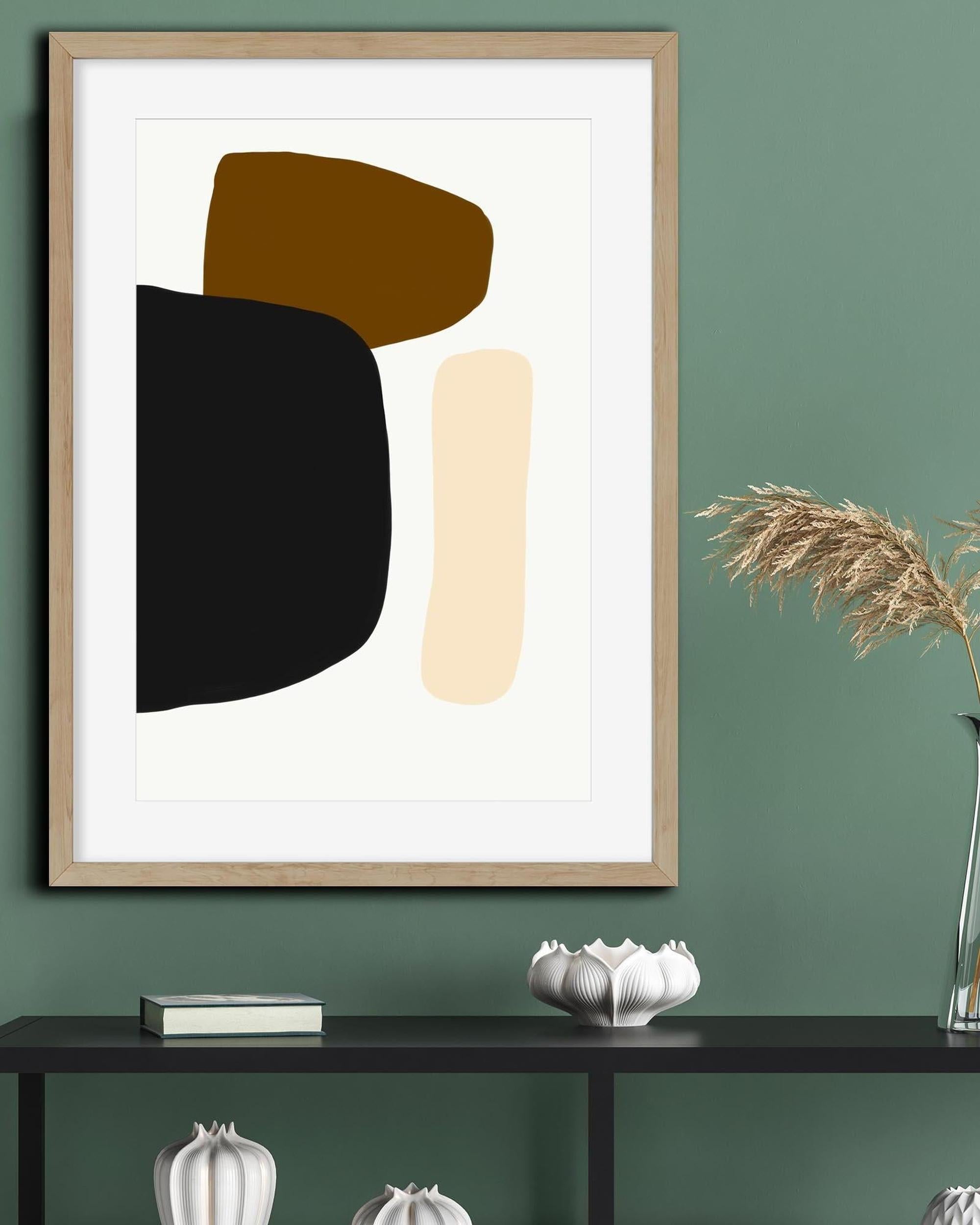 Abstract art print with geometric shapes in a wooden frame on a green wall.