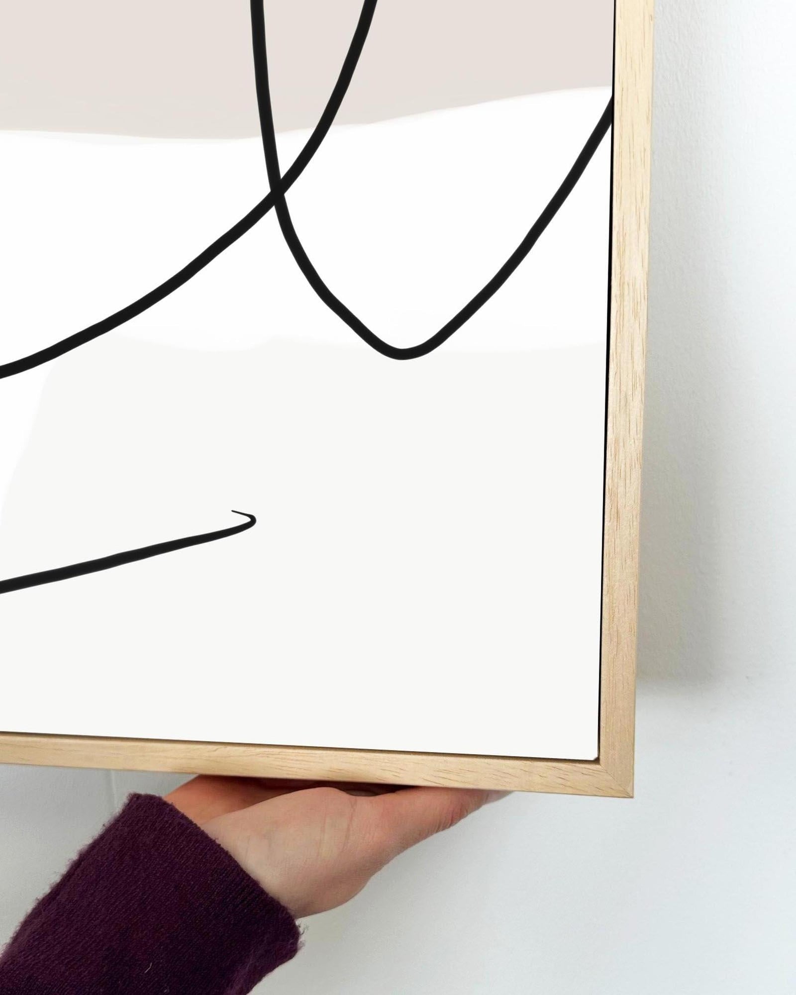 Framed abstract art with black lines on a white background