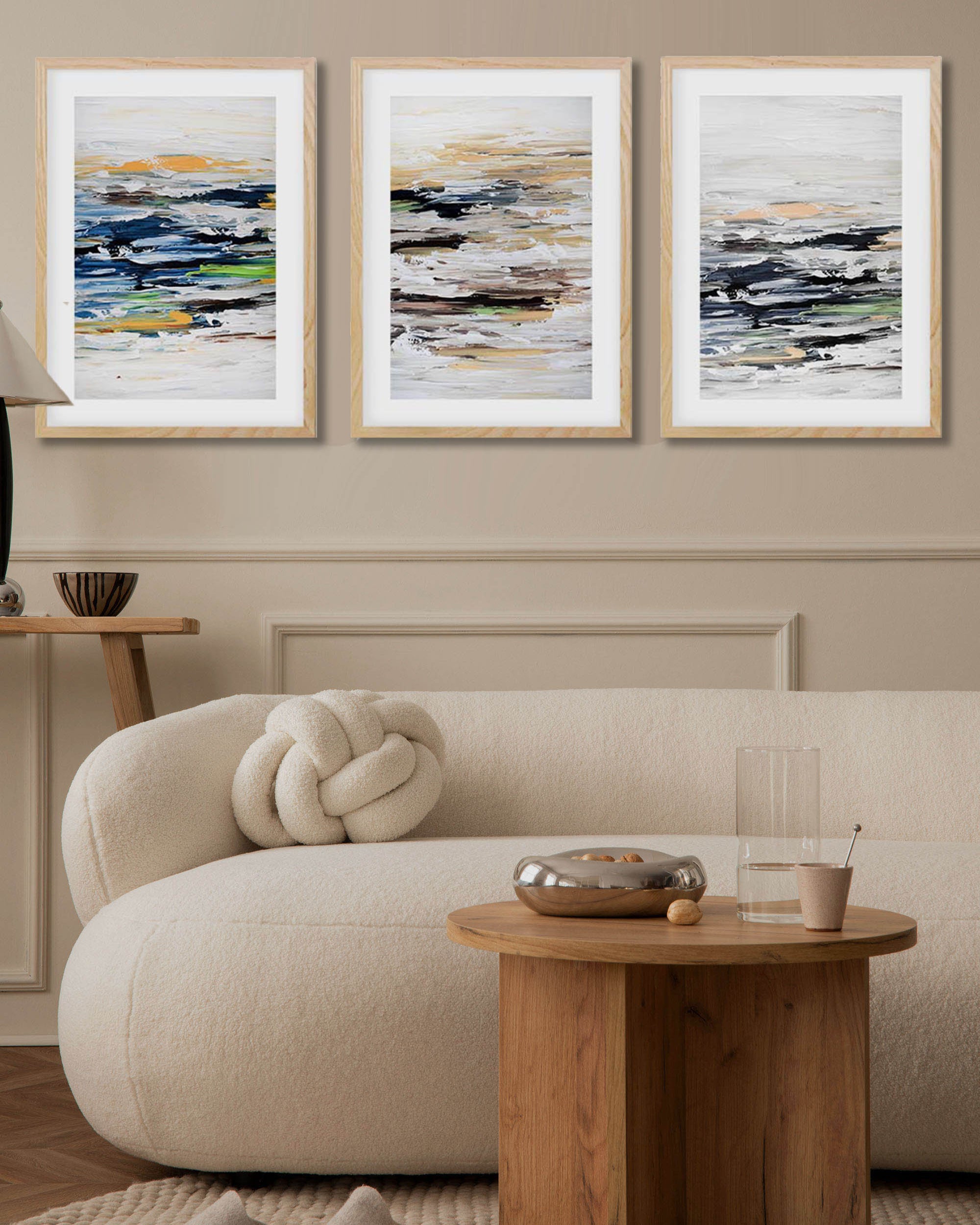 Japandi living room decor. Modern living room with a beige sofa, wooden coffee table, and abstract art on the wall.