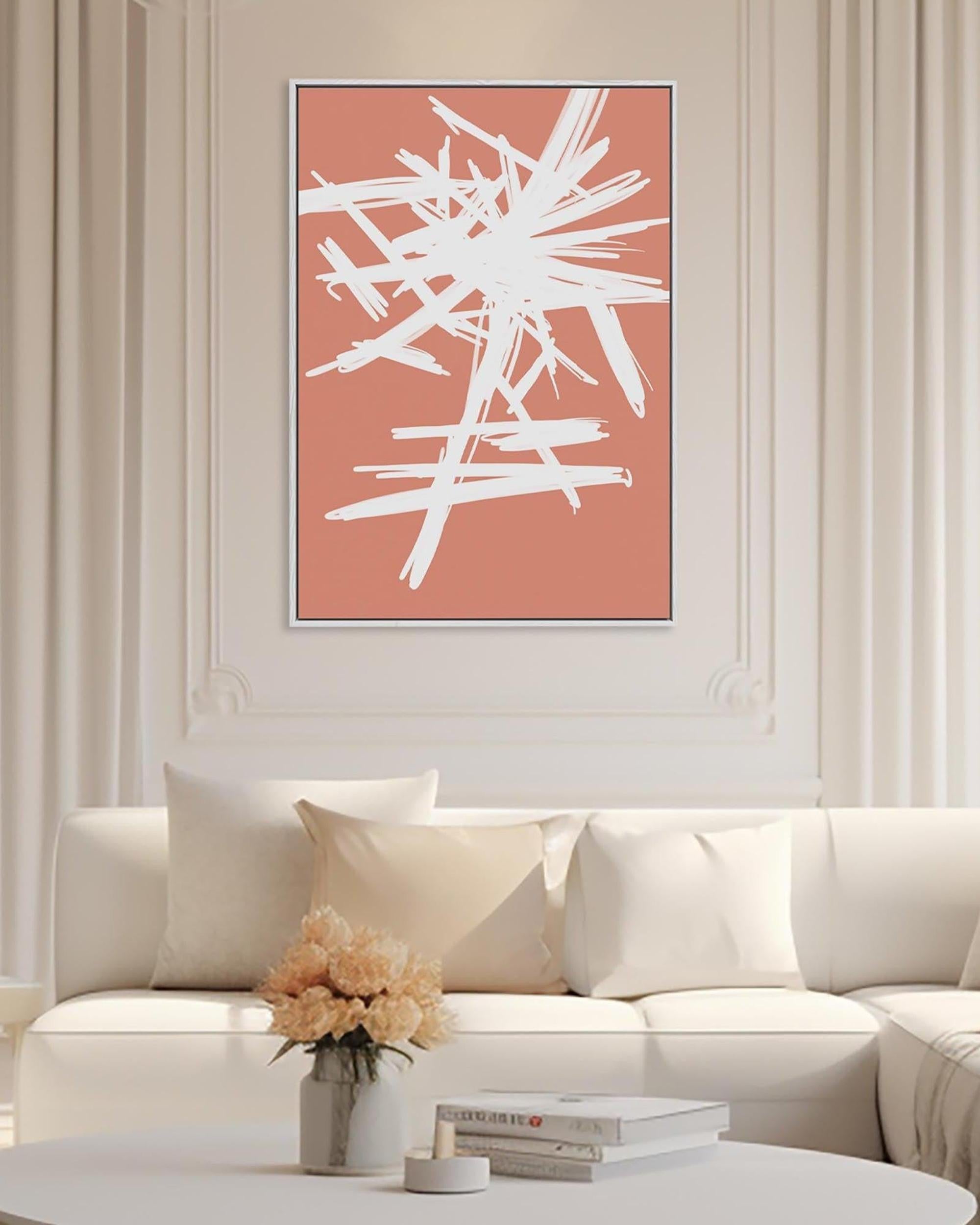 Abstract white artwork on a coral background in a living room setting.