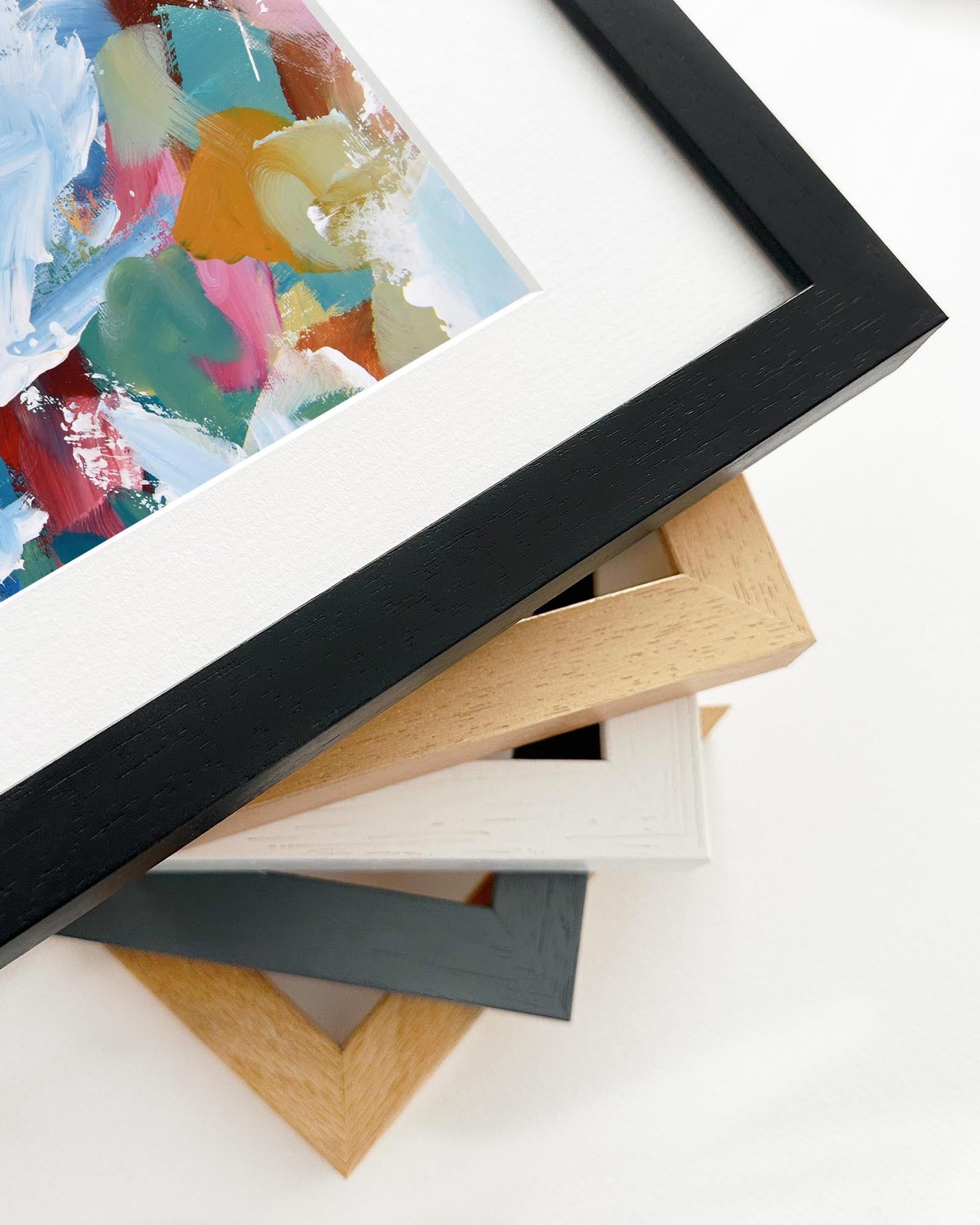 Stack of various photo frames on a white surface