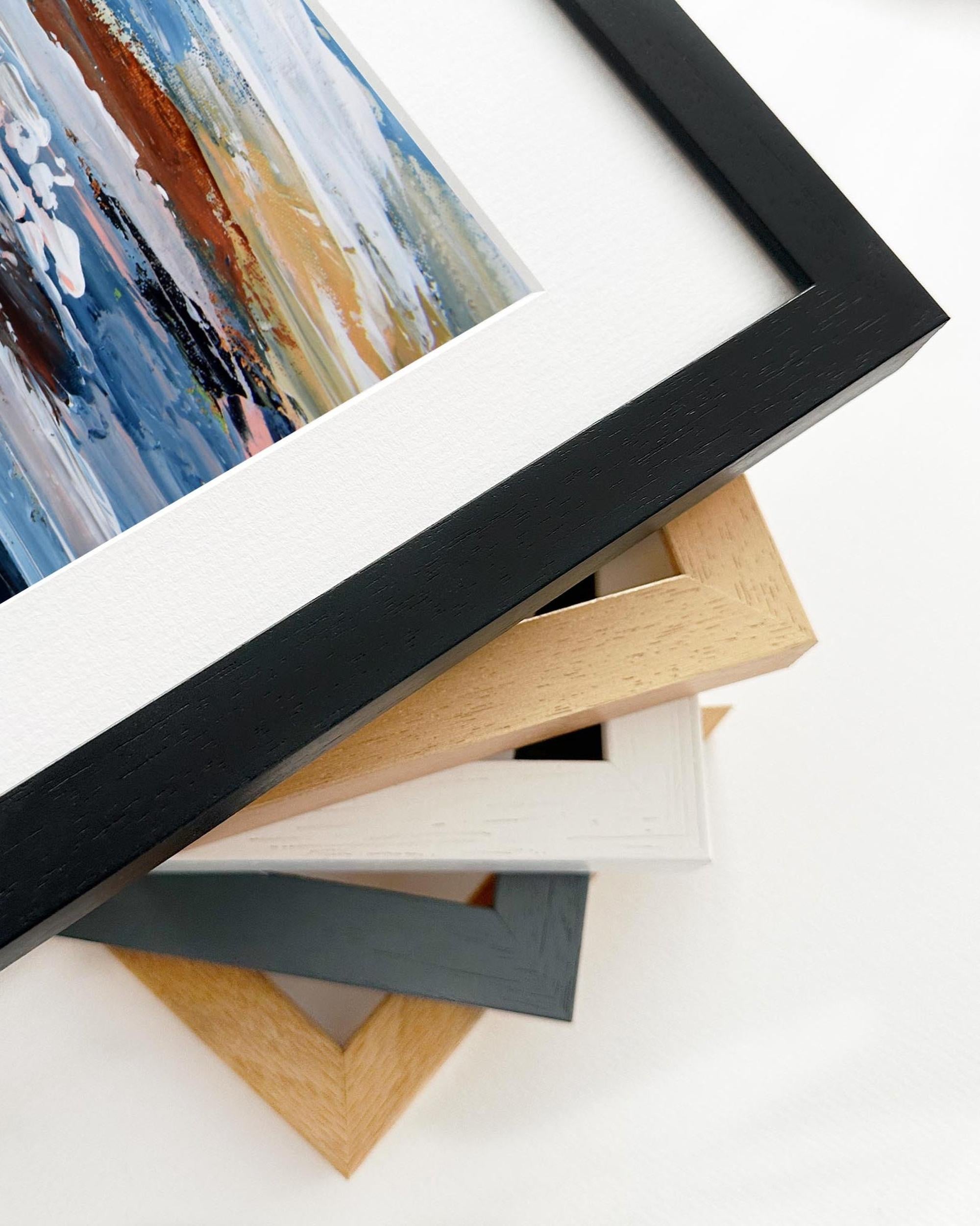 Stack of variously colored picture frames on a white background