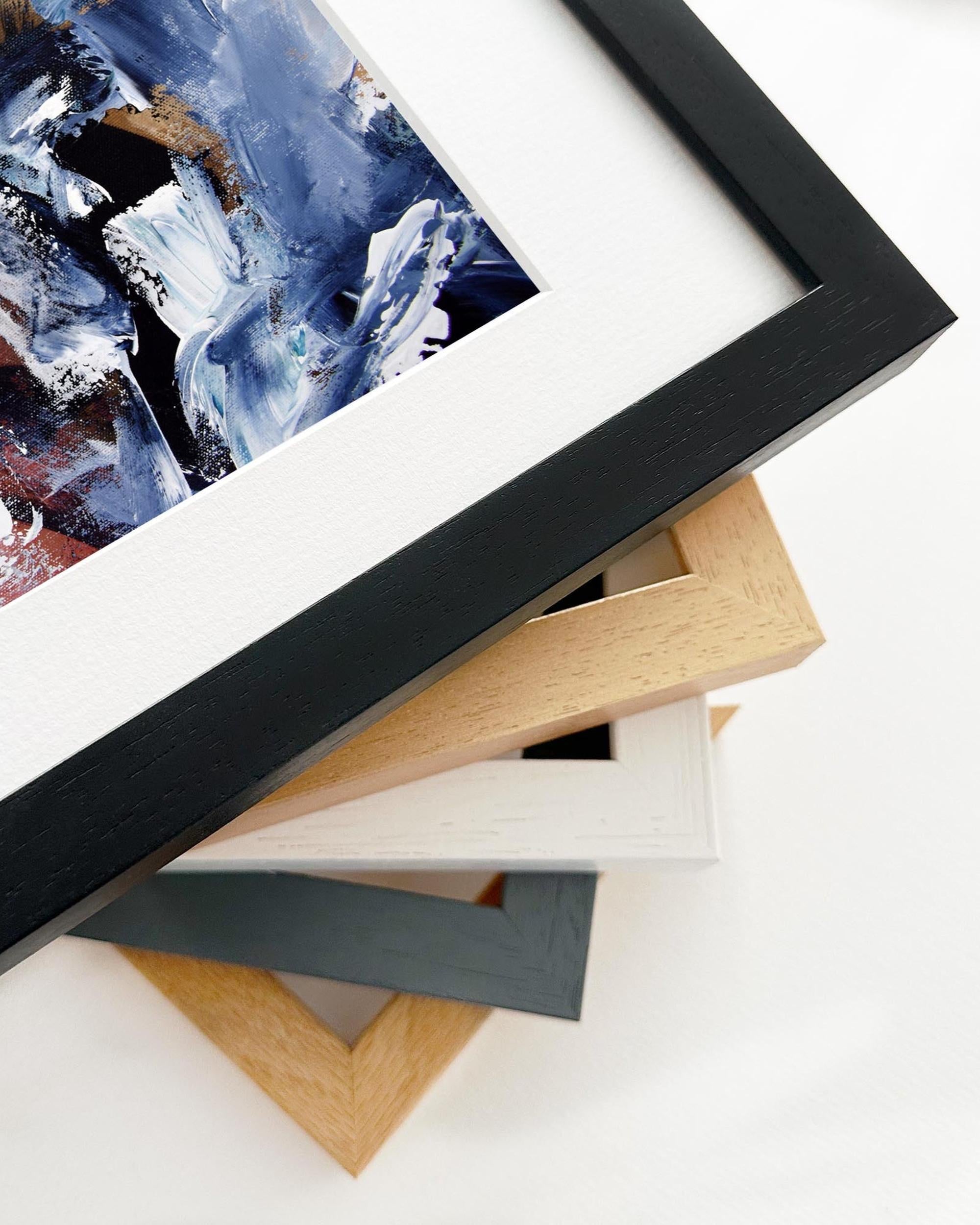 Framed abstract artwork with various frame options on a white surface
