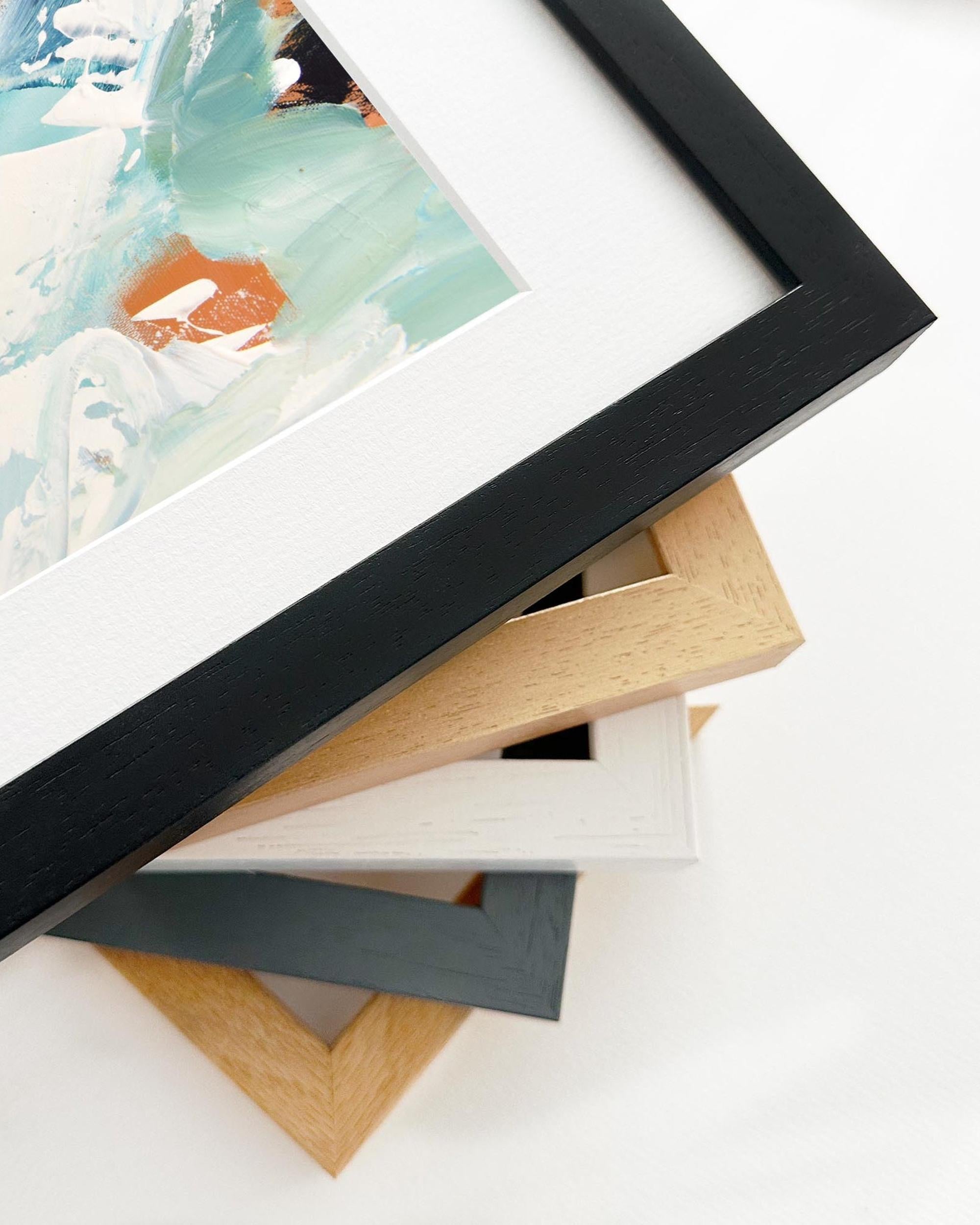 Stack of various photo frames on a white surface