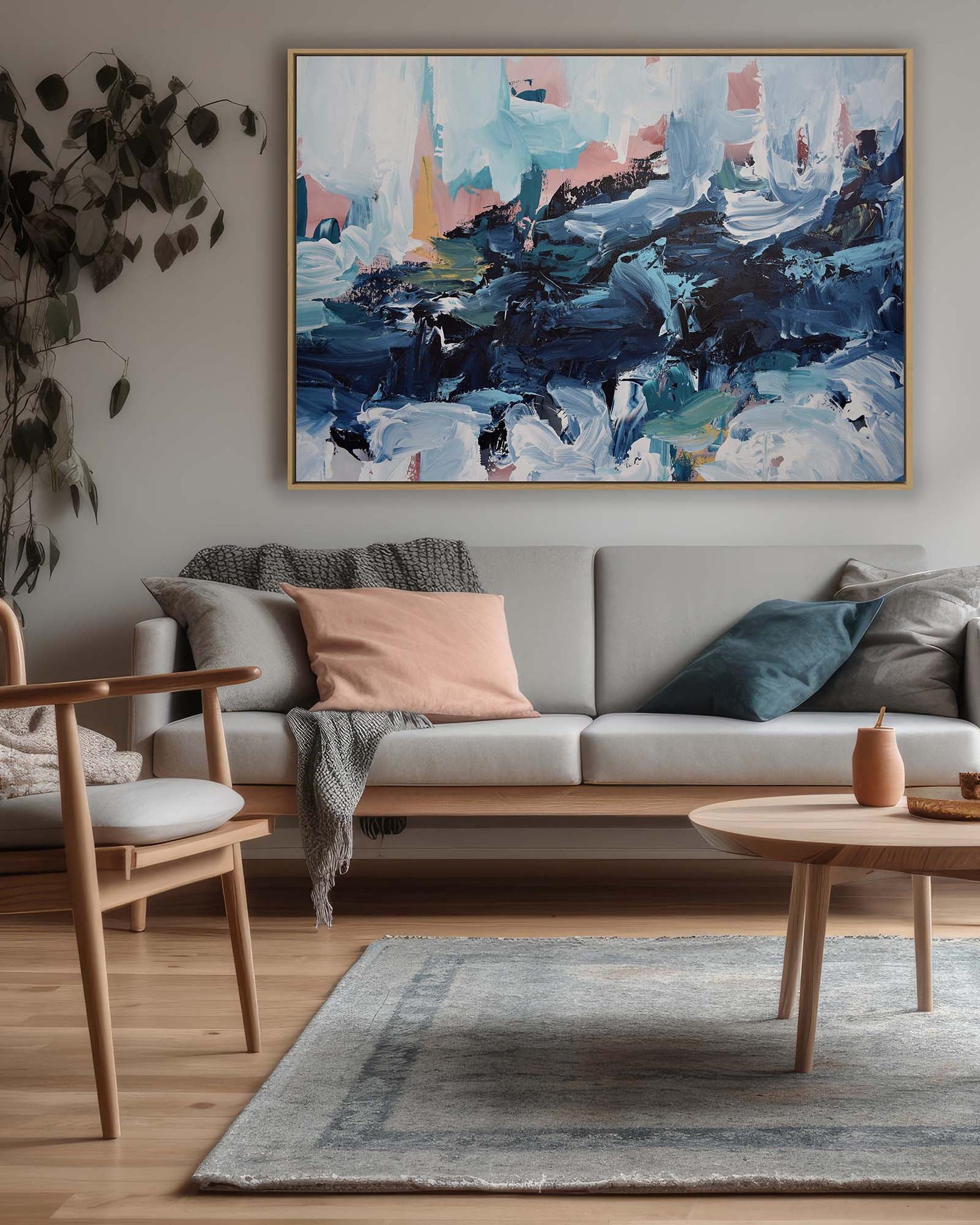 Living room with a gray sofa, abstract painting on the wall, and wooden coffee table.