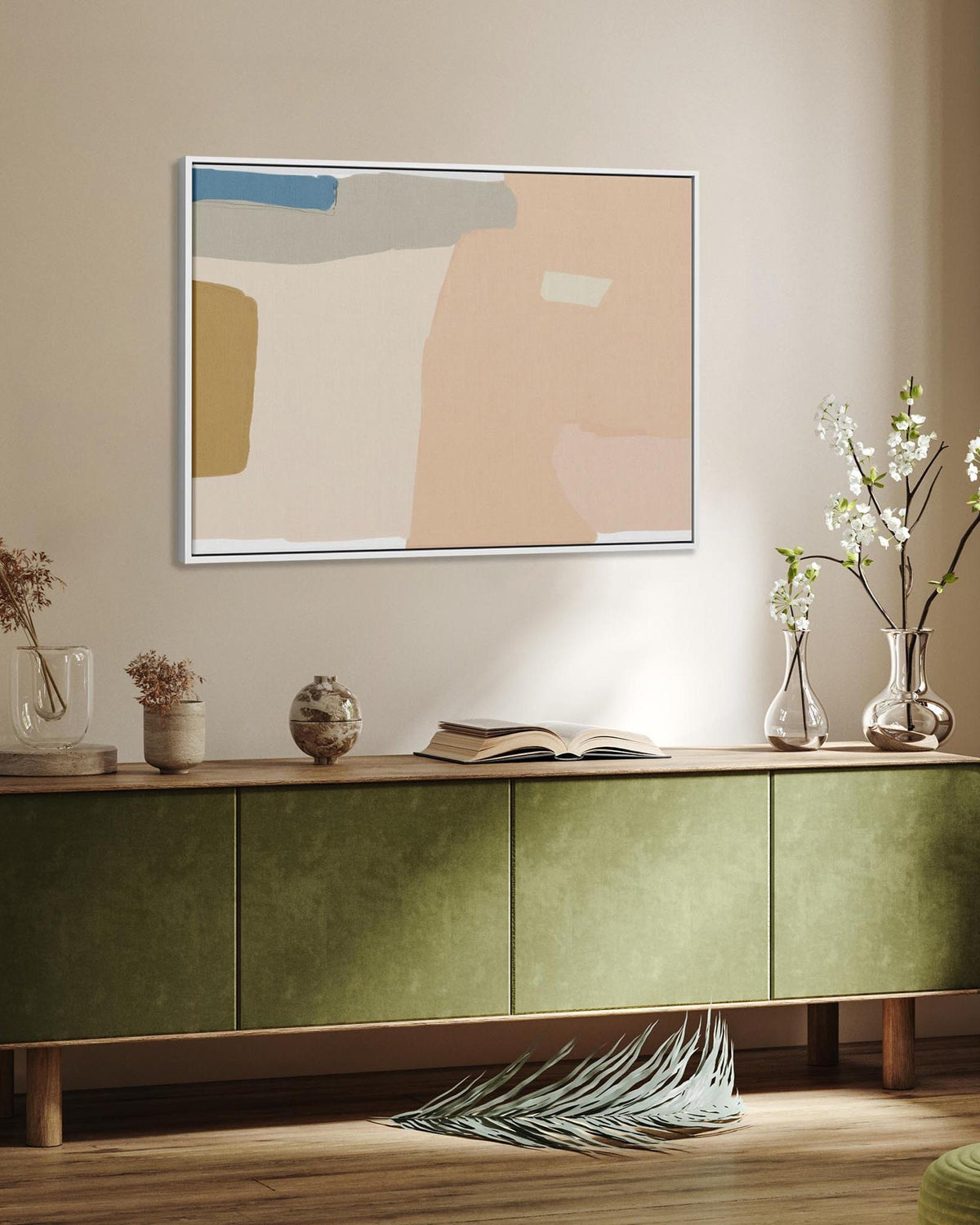 Modern living room with a green sideboard, abstract painting, and decorative items.