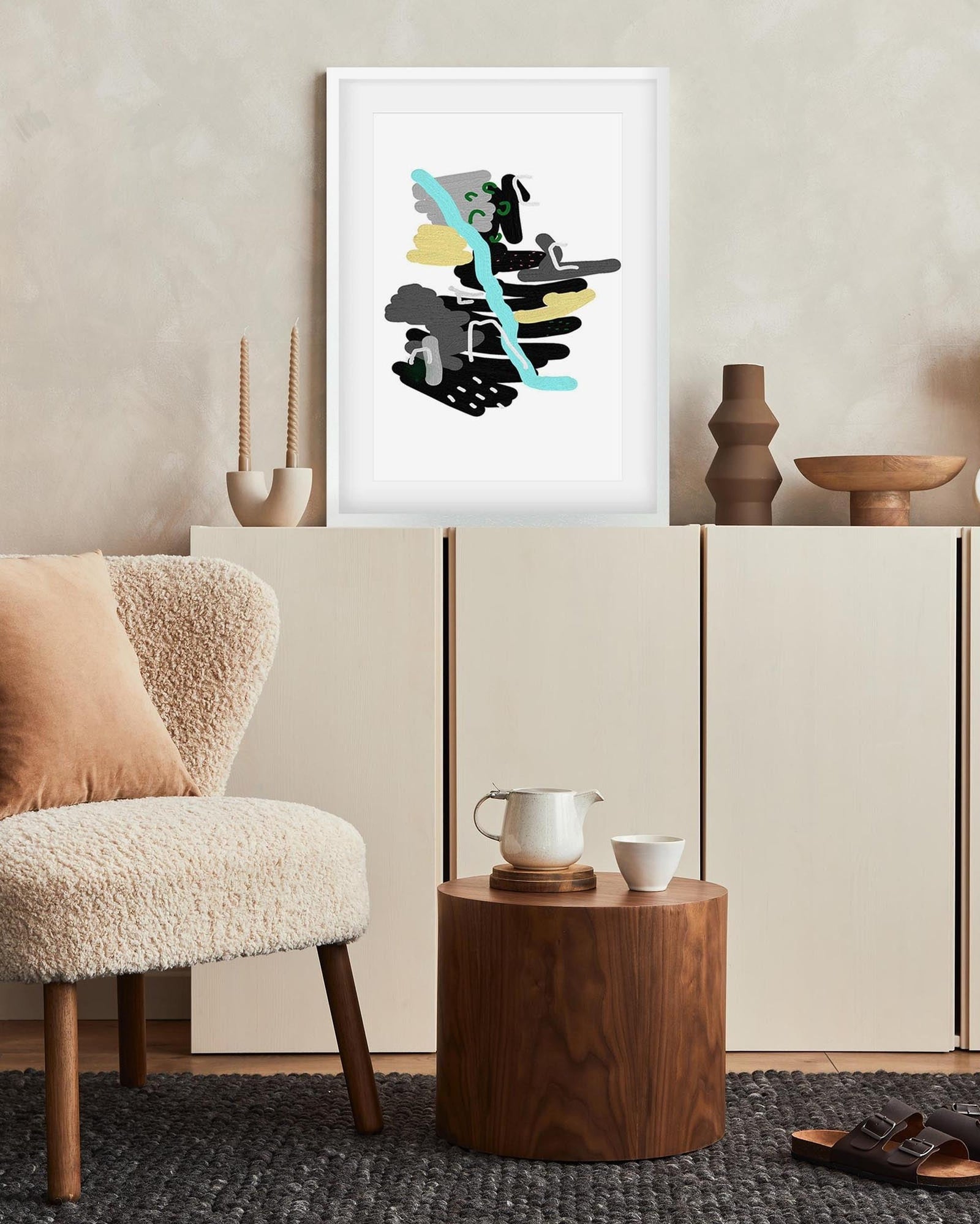 Modern interior with a chair, side table, and abstract art on the wall.