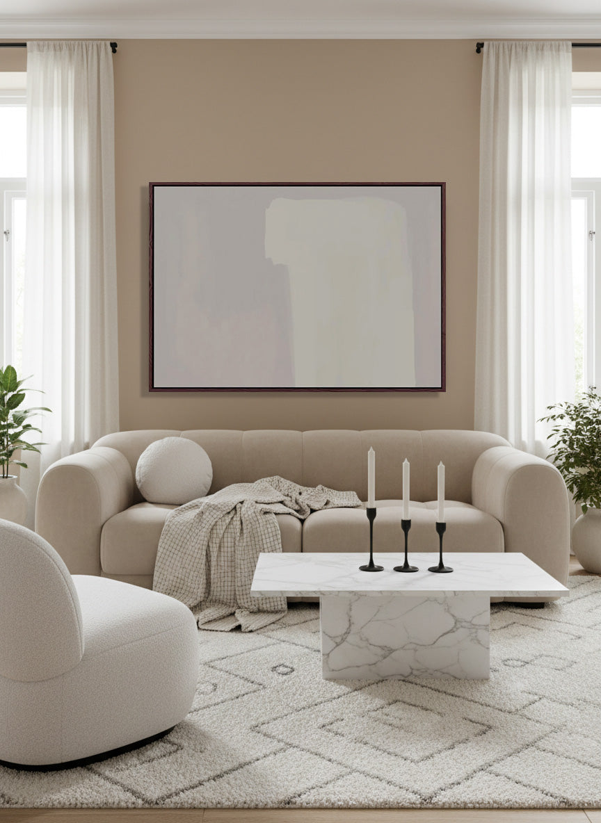 Modern living room with beige sofa, marble coffee table, and abstract art on wall.