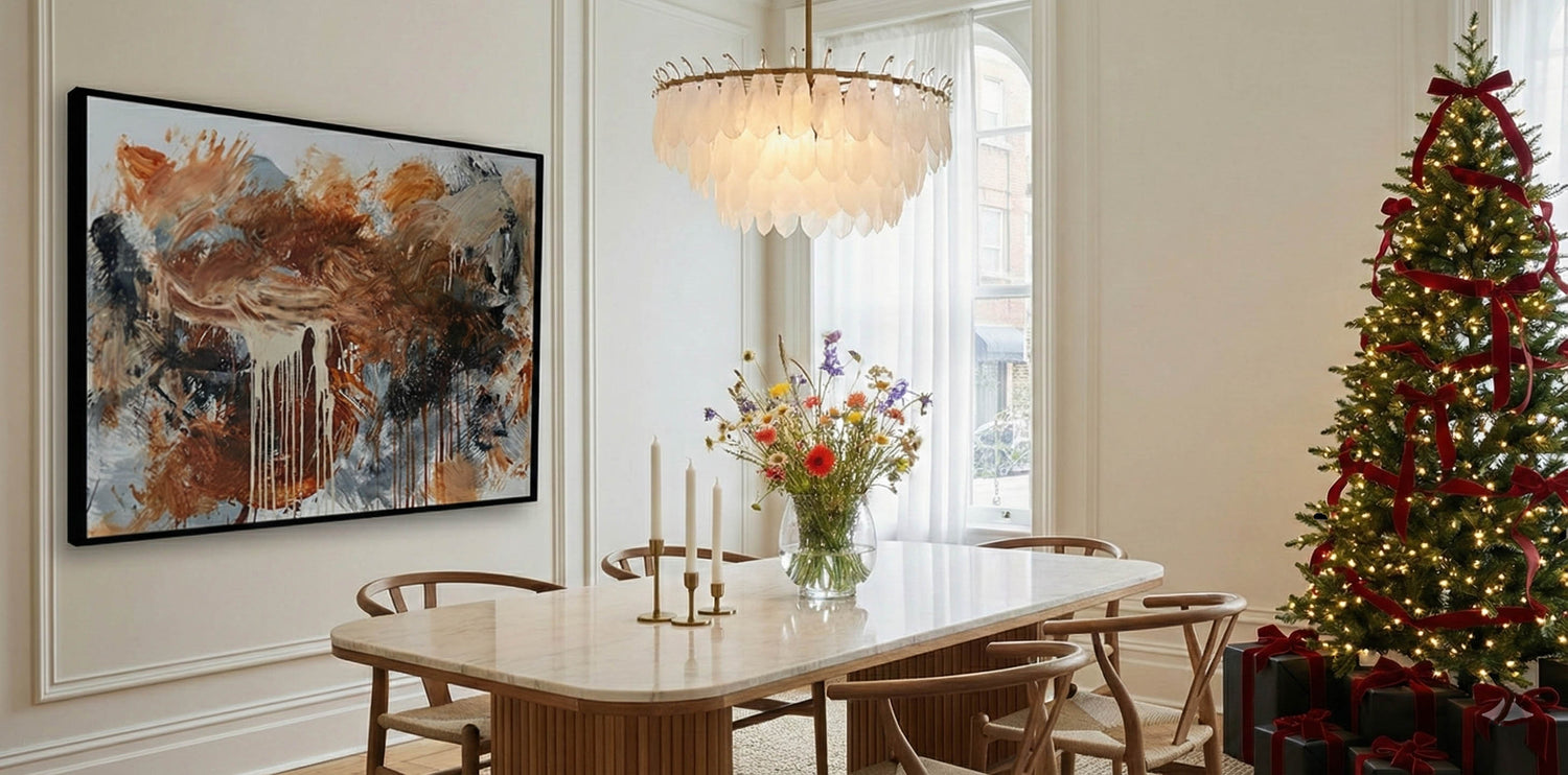 modern living room with large brown original abstract painting on wall and luxury Christmas tree with dining table and classic ercol dining chairs