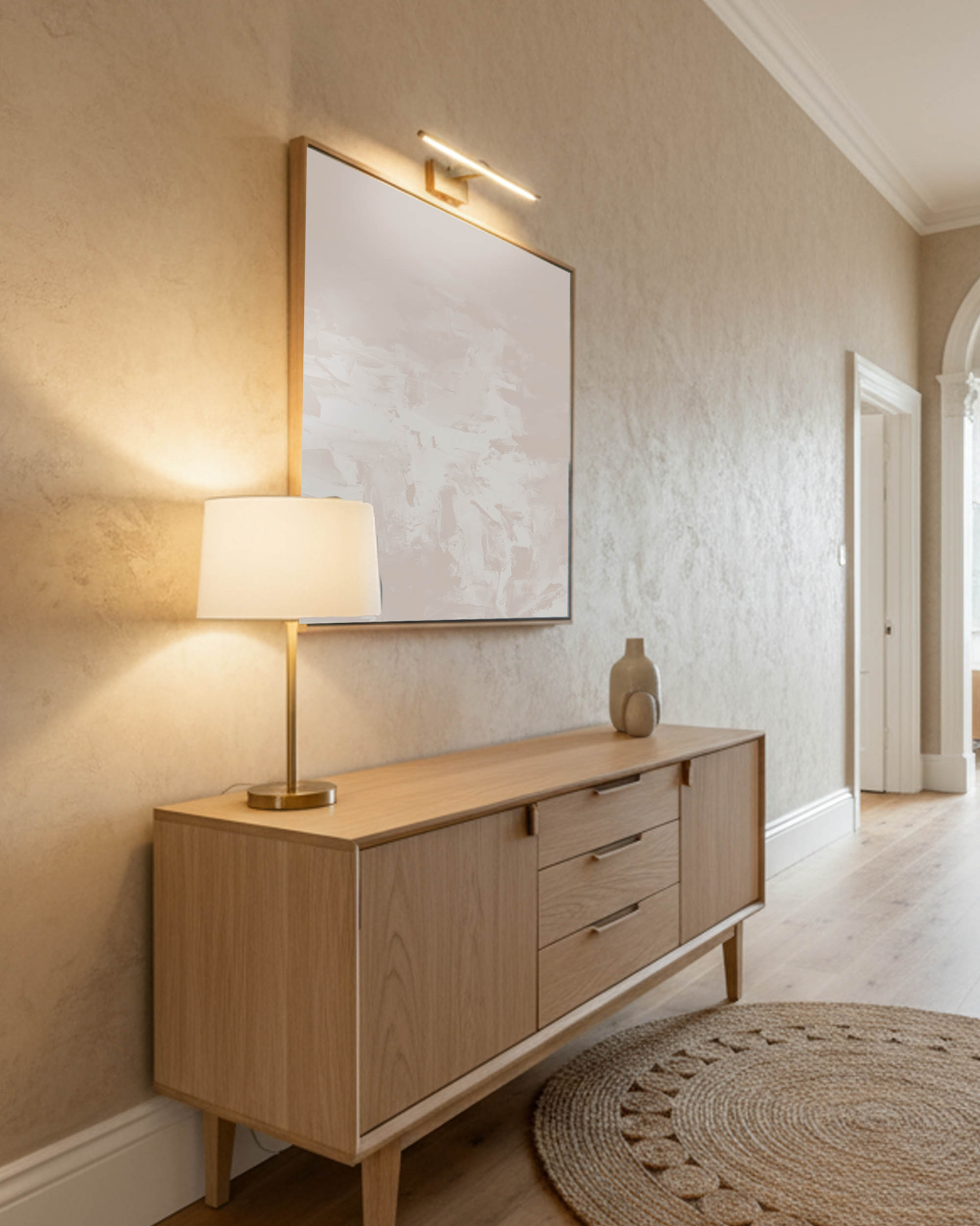 modern neutral wall art, minimal canvas painting in scandinavian warm hallway with lamp and textured wallpaper in beige.