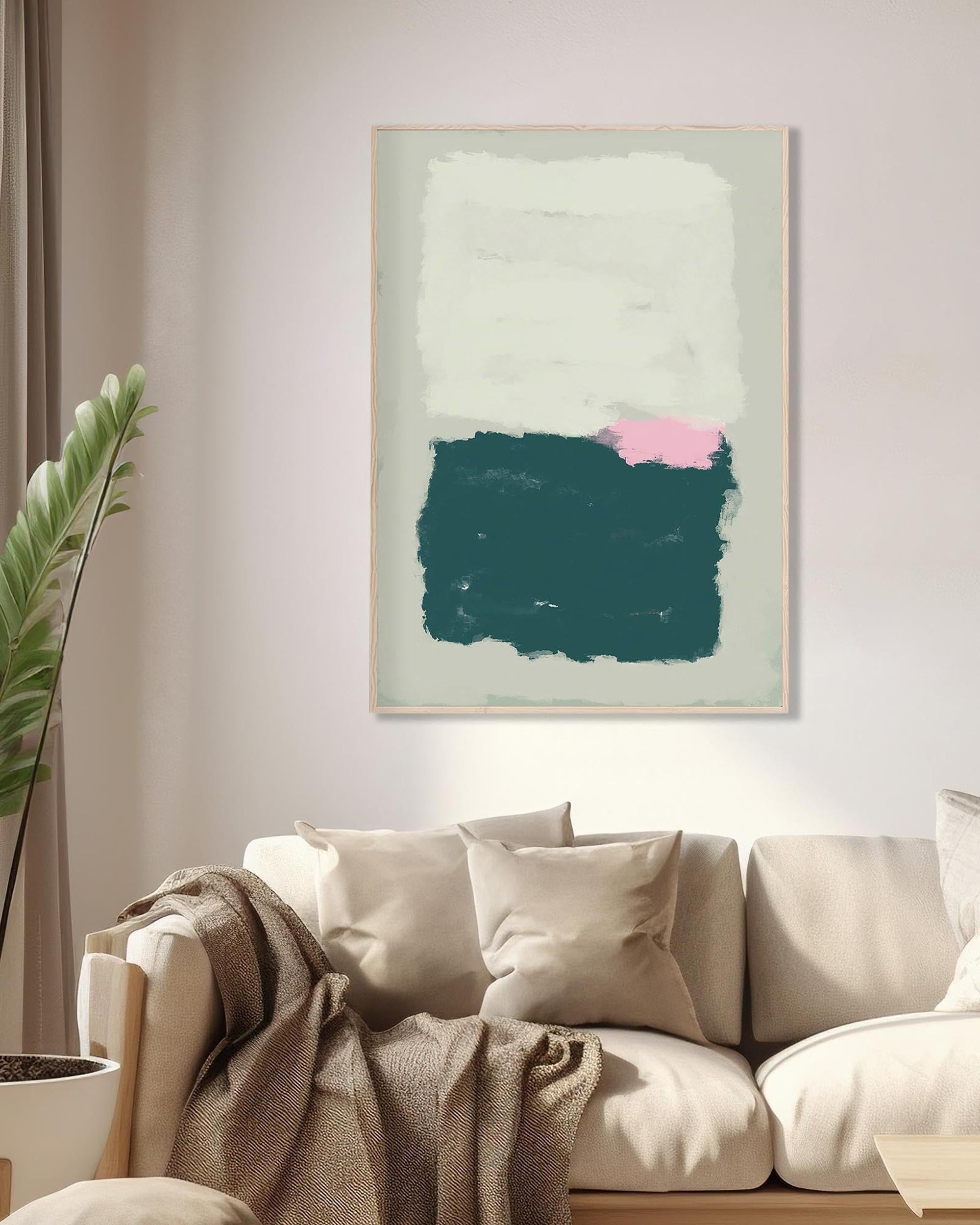 Abstract art print on a wall above a sofa with a plant to the left.