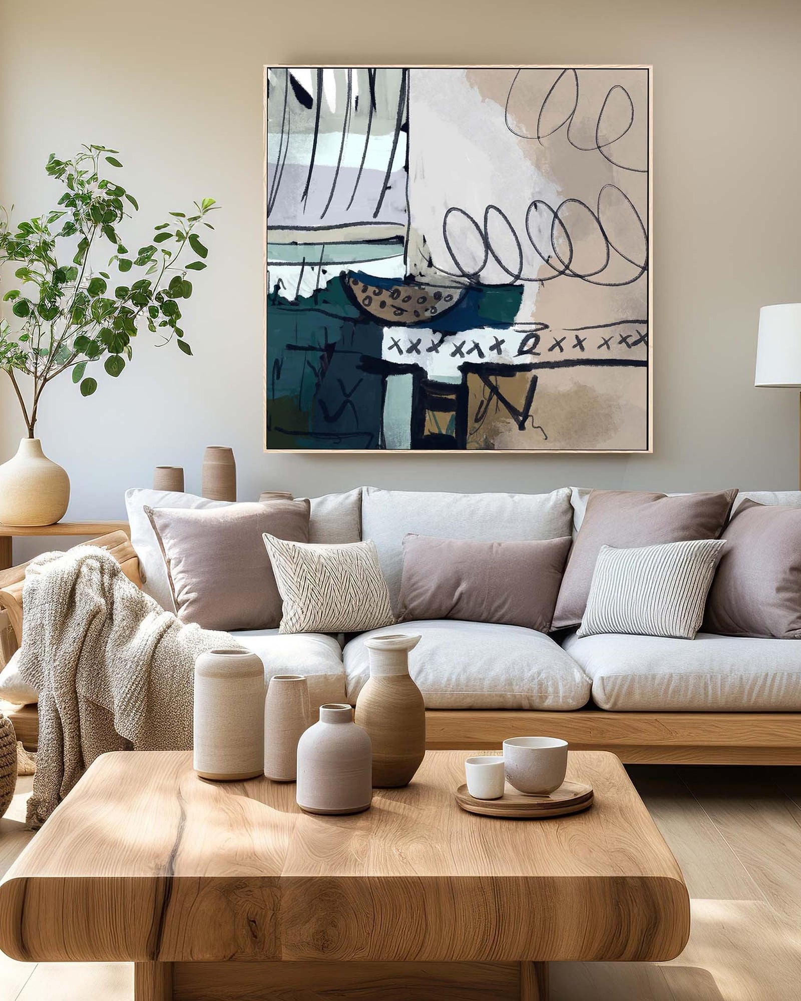 Modern living room with a sofa, coffee table, and abstract art on the wall.