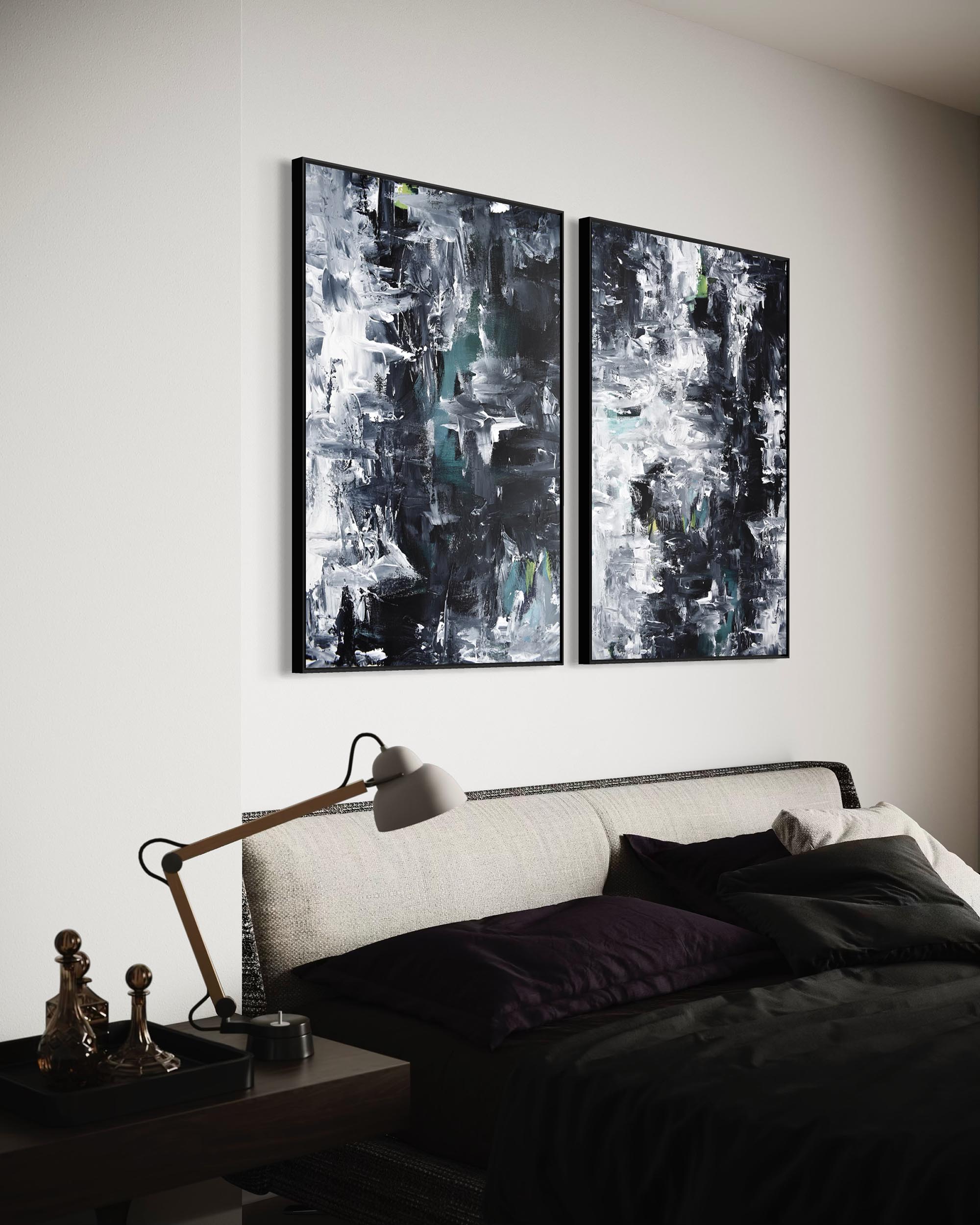 Two abstract paintings on a wall above a bed in a bedroom.