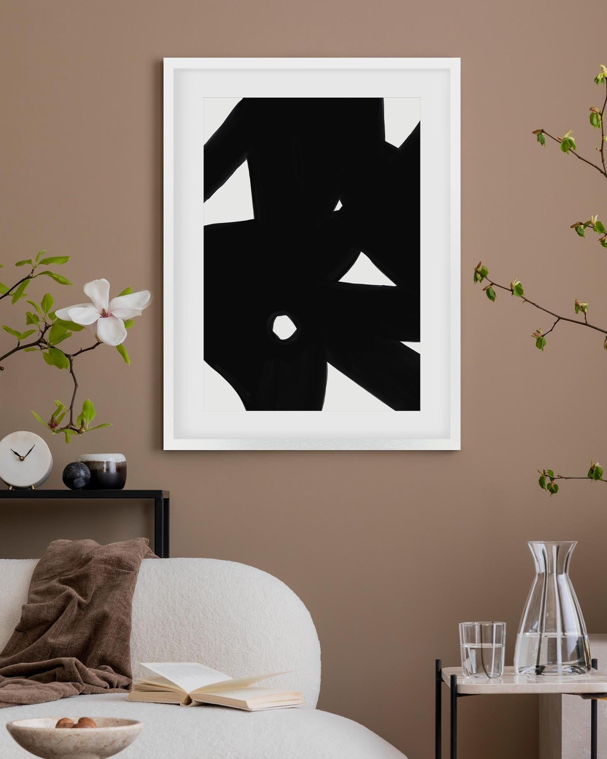 Abstract black and white artwork on a brown wall with decorative elements.