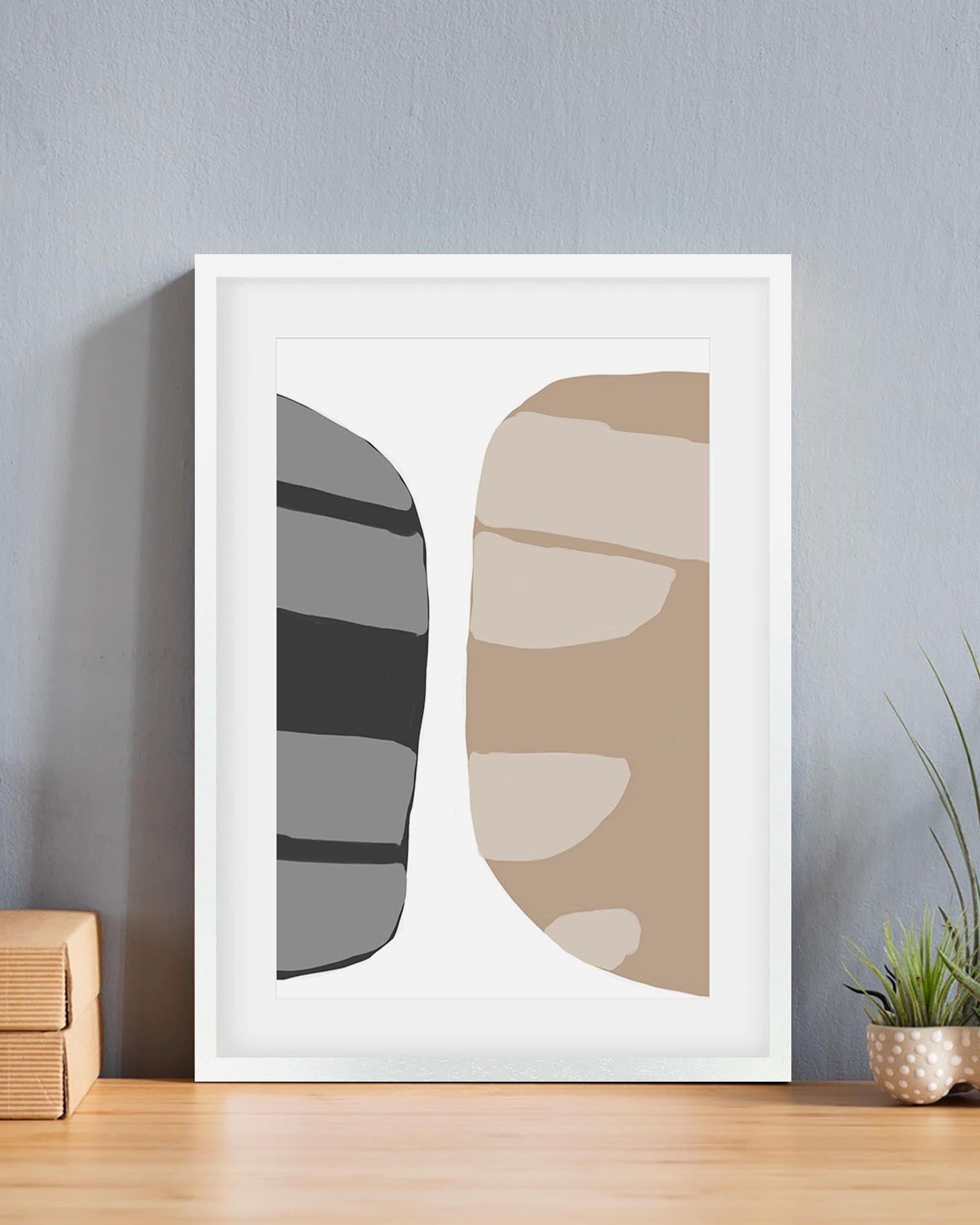 Framed abstract art print with geometric shapes on a wall.