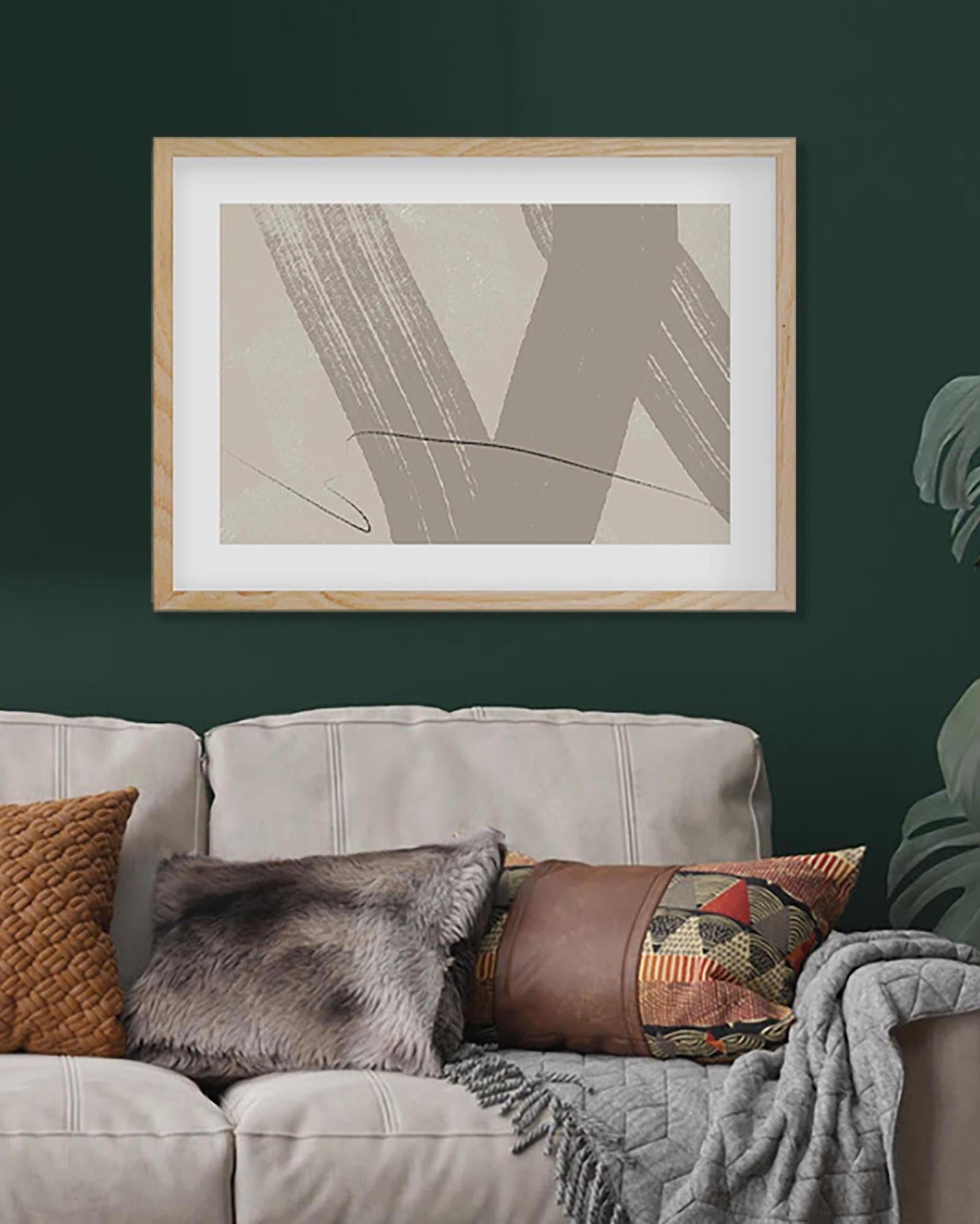 Framed abstract art above a sofa with decorative pillows on a dark green wall.