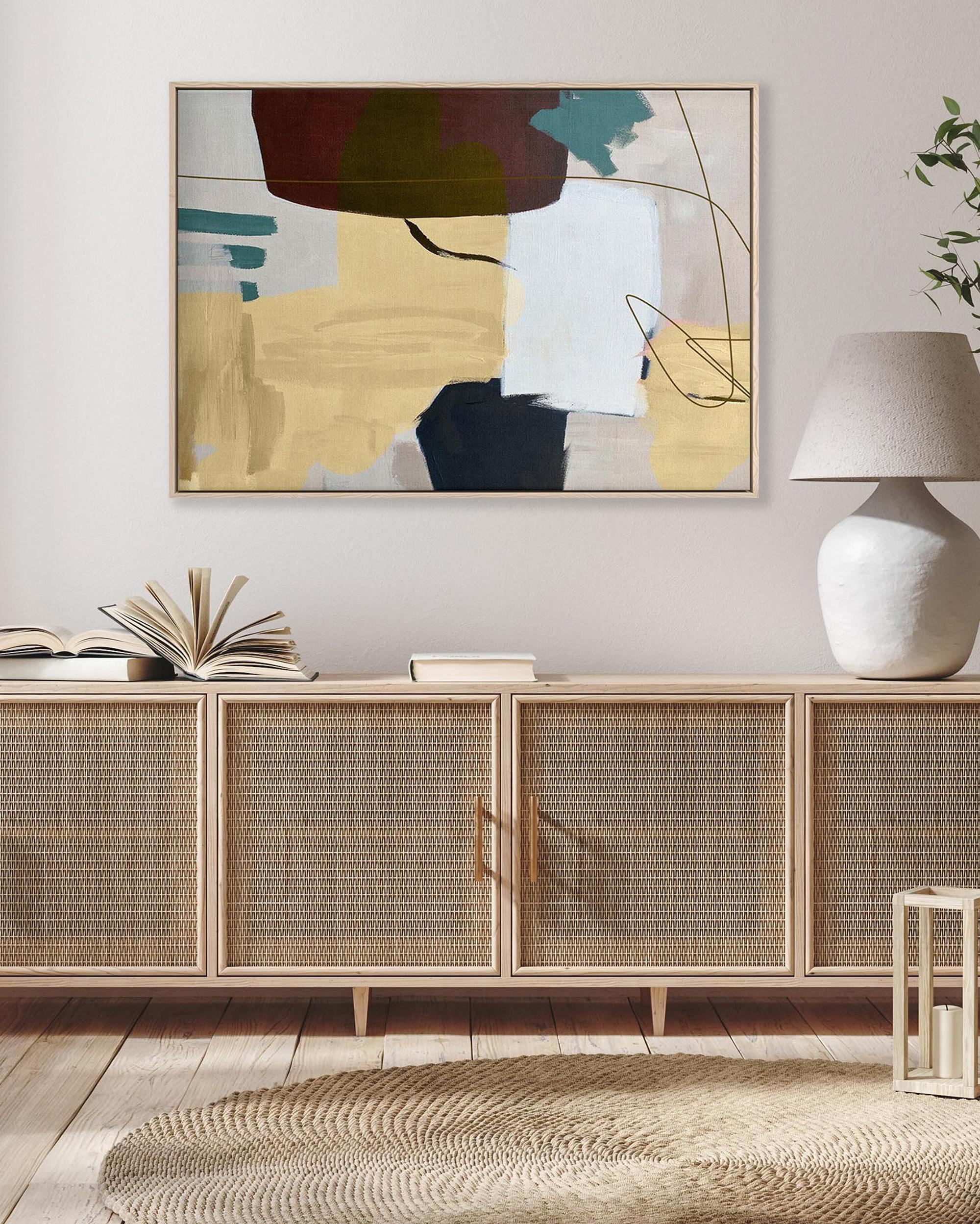 Living room with a wooden sideboard, abstract painting, and decorative items.