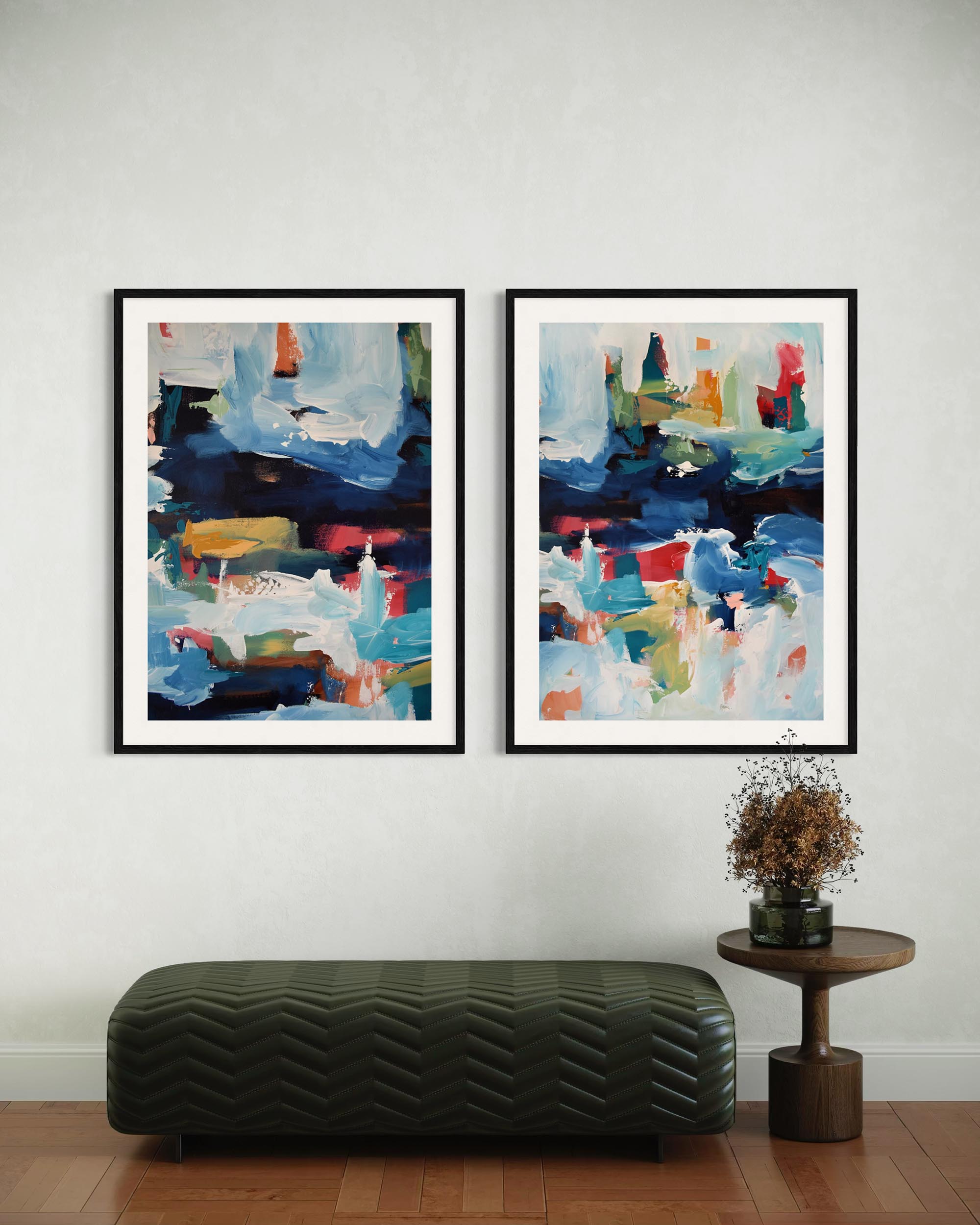 Two abstract paintings on a wall with a bench and small table below.