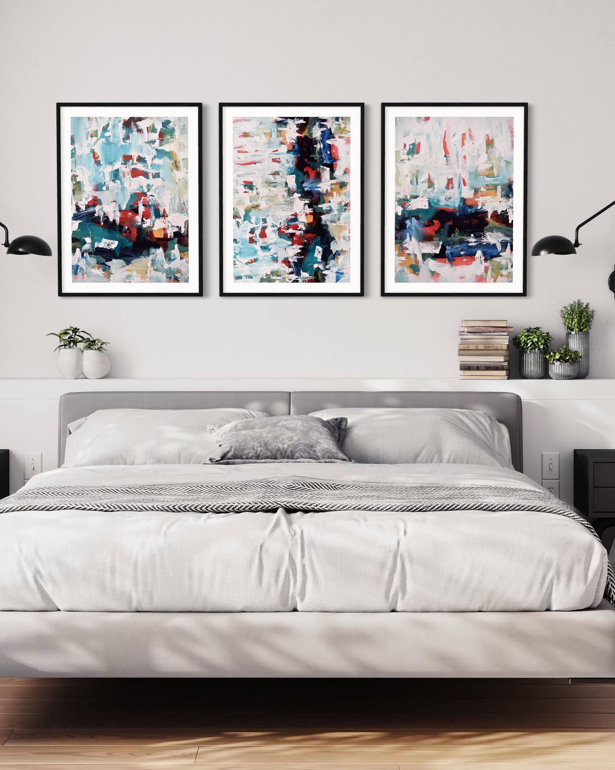 Three abstract art pieces above a bed in a bedroom setting.