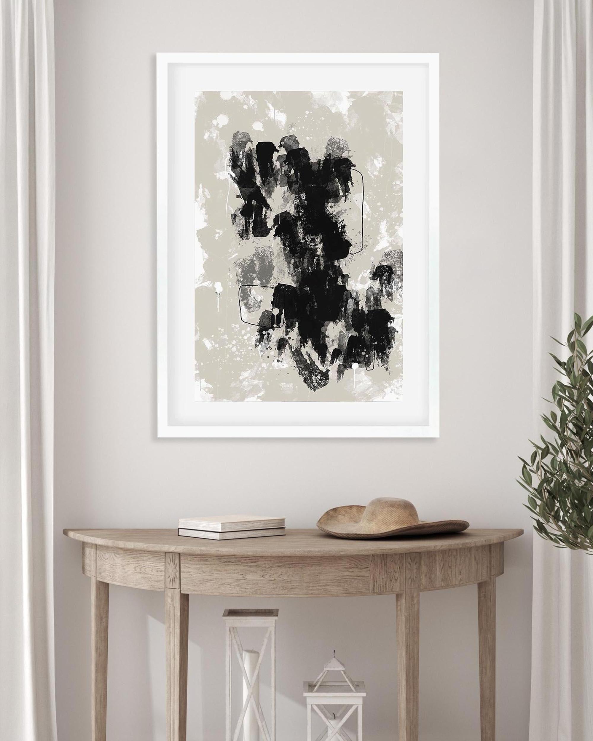 Framed abstract art print on a wall above a wooden console table.