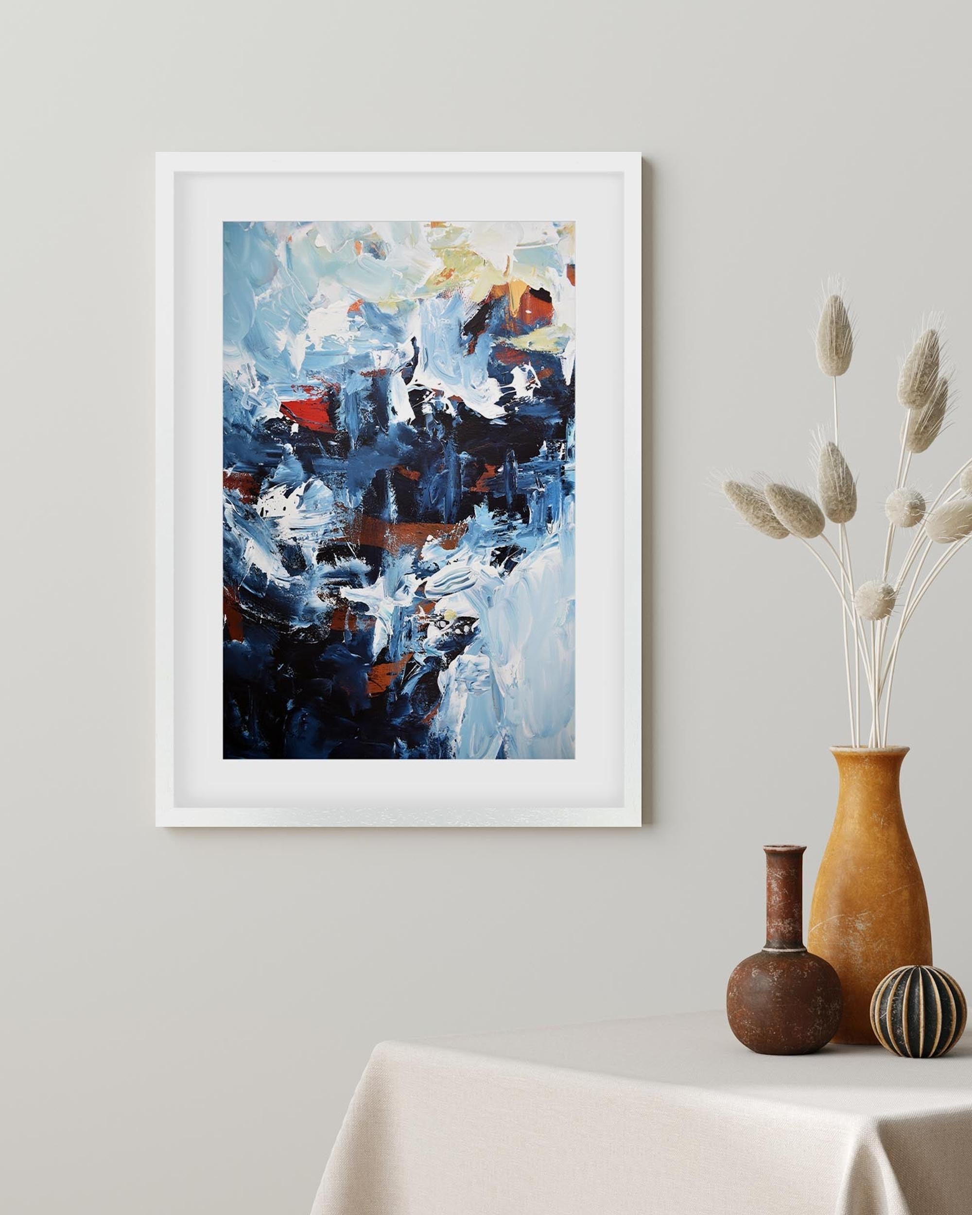 Abstract painting in a white frame on a wall above a table with decorative vases.