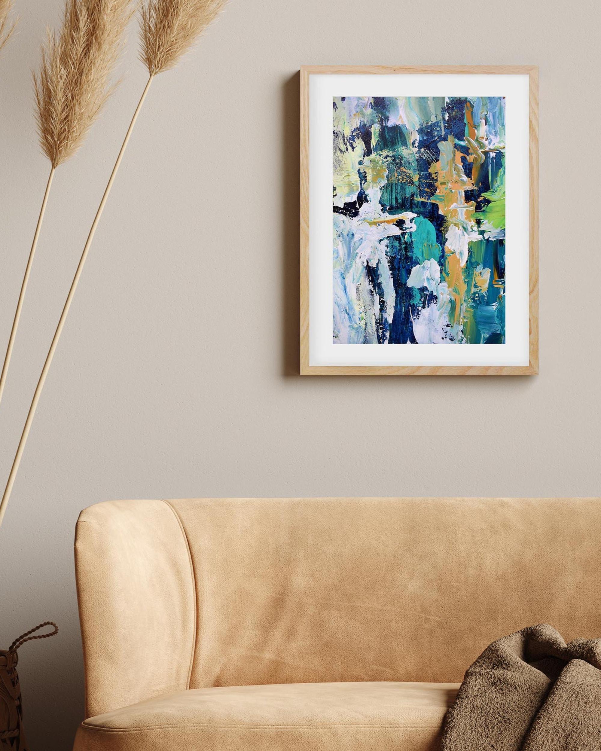 Abstract painting on a wall above a beige sofa with decorative elements.