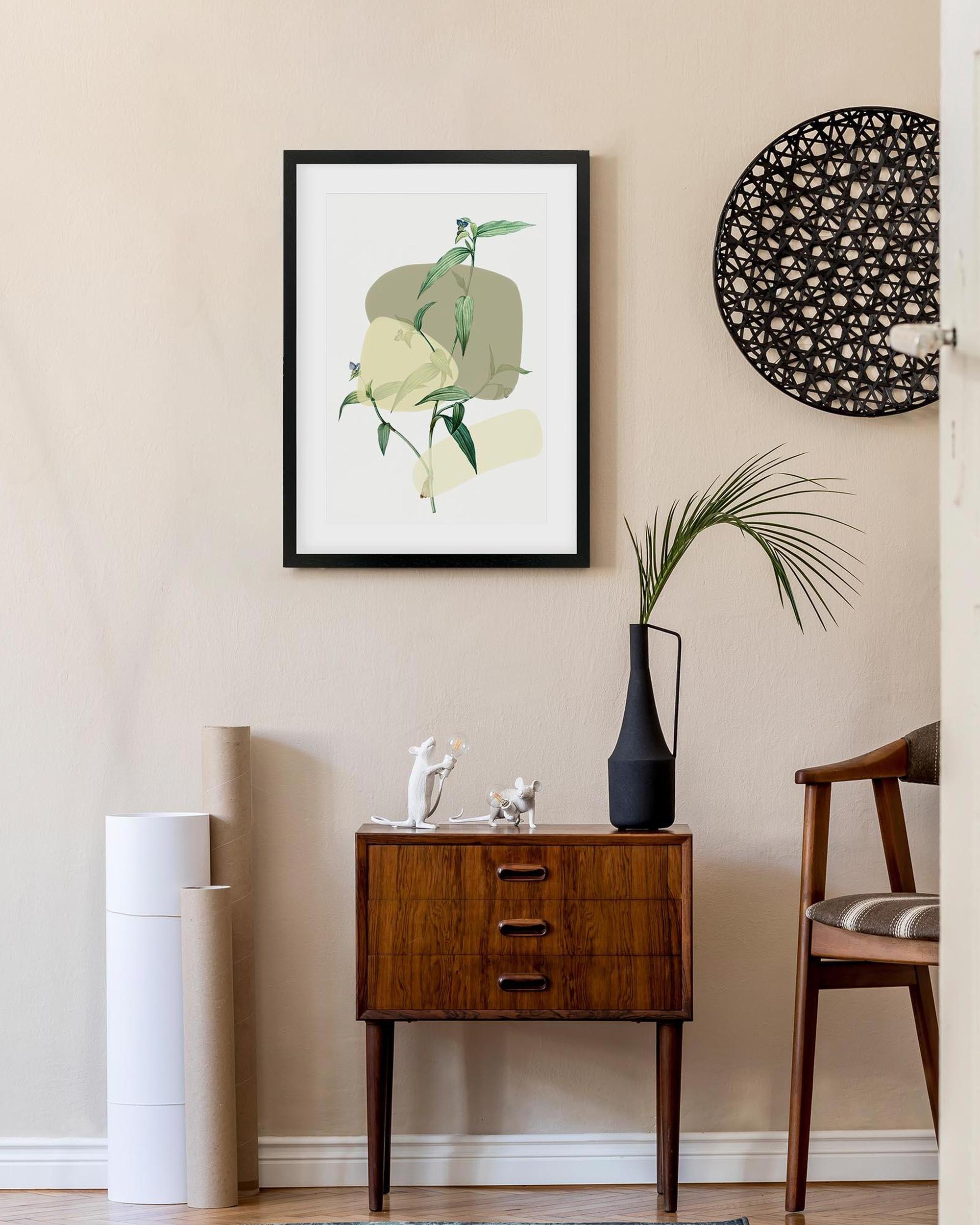 Modern interior with a wooden side table, framed artwork, and decorative items.