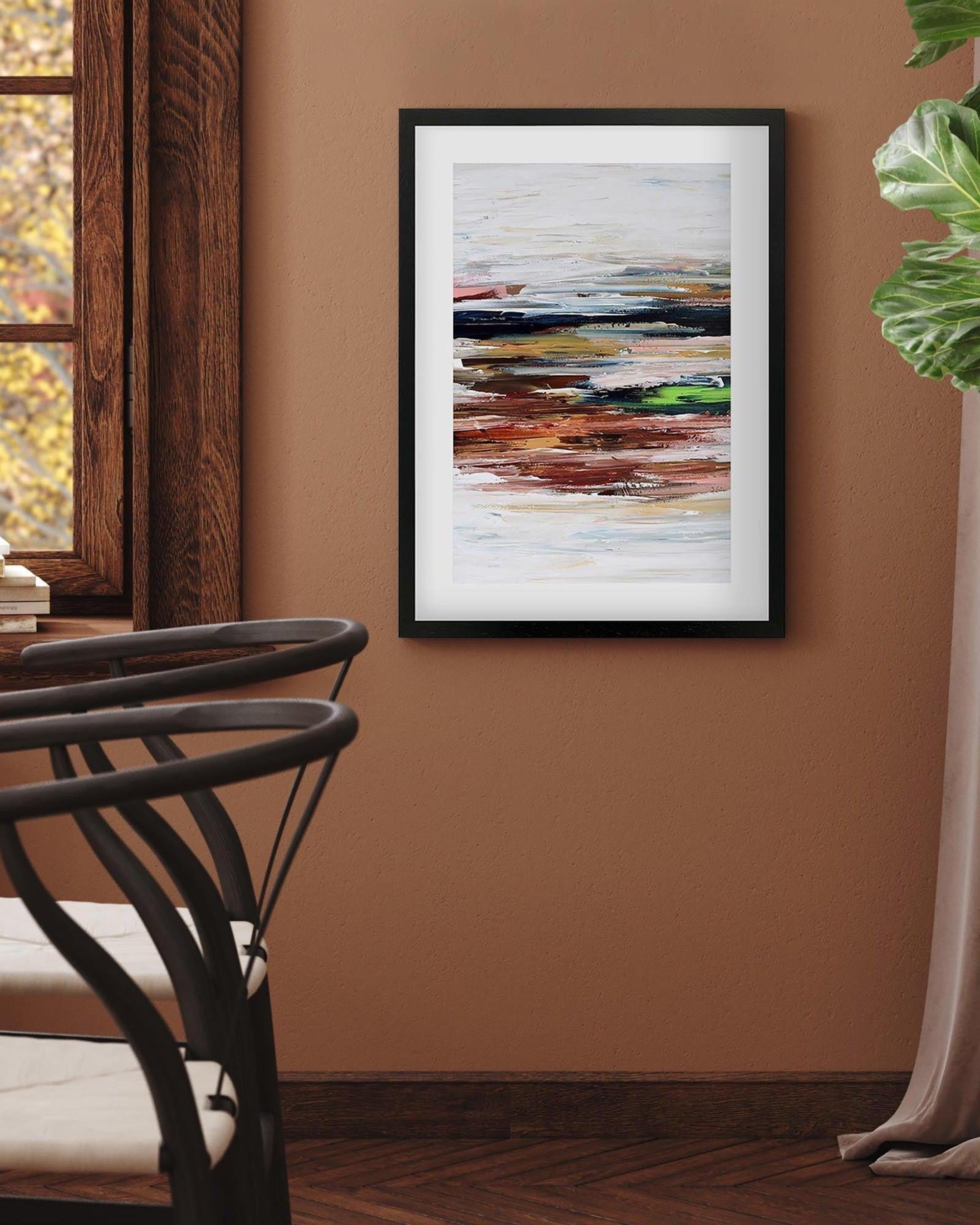Framed abstract painting on a brown wall with a chair and plant in the foreground