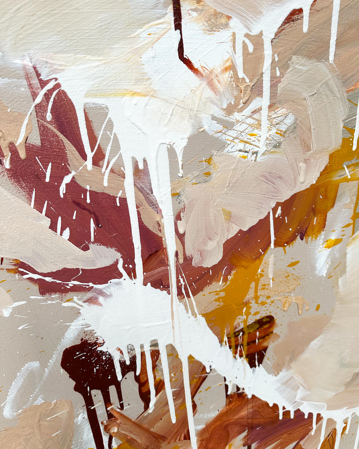 Abstract art with splashes of white, red, yellow, and brown on a beige background