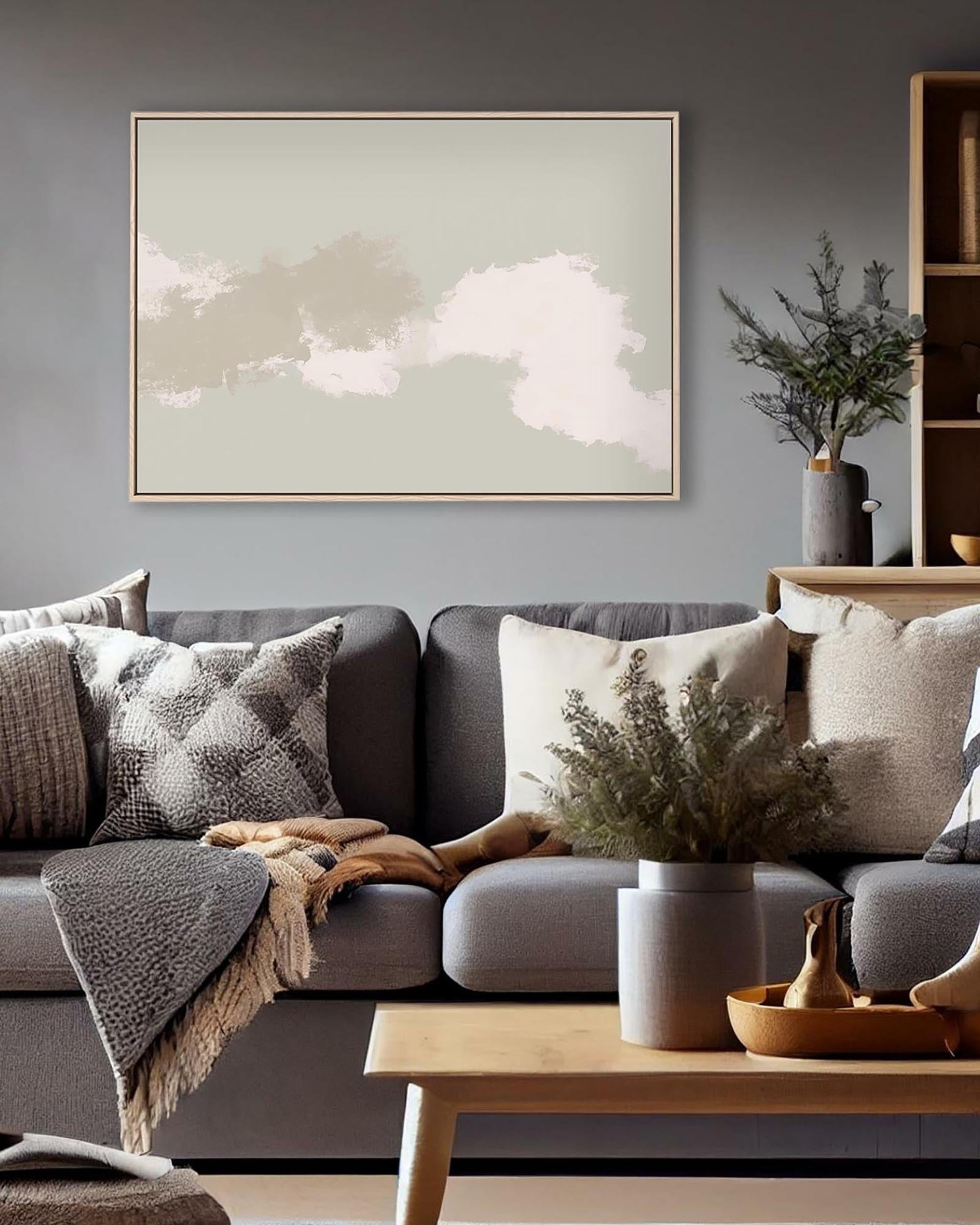 Cozy living room with a gray sofa, decorative pillows, and a framed abstract painting on the wall.