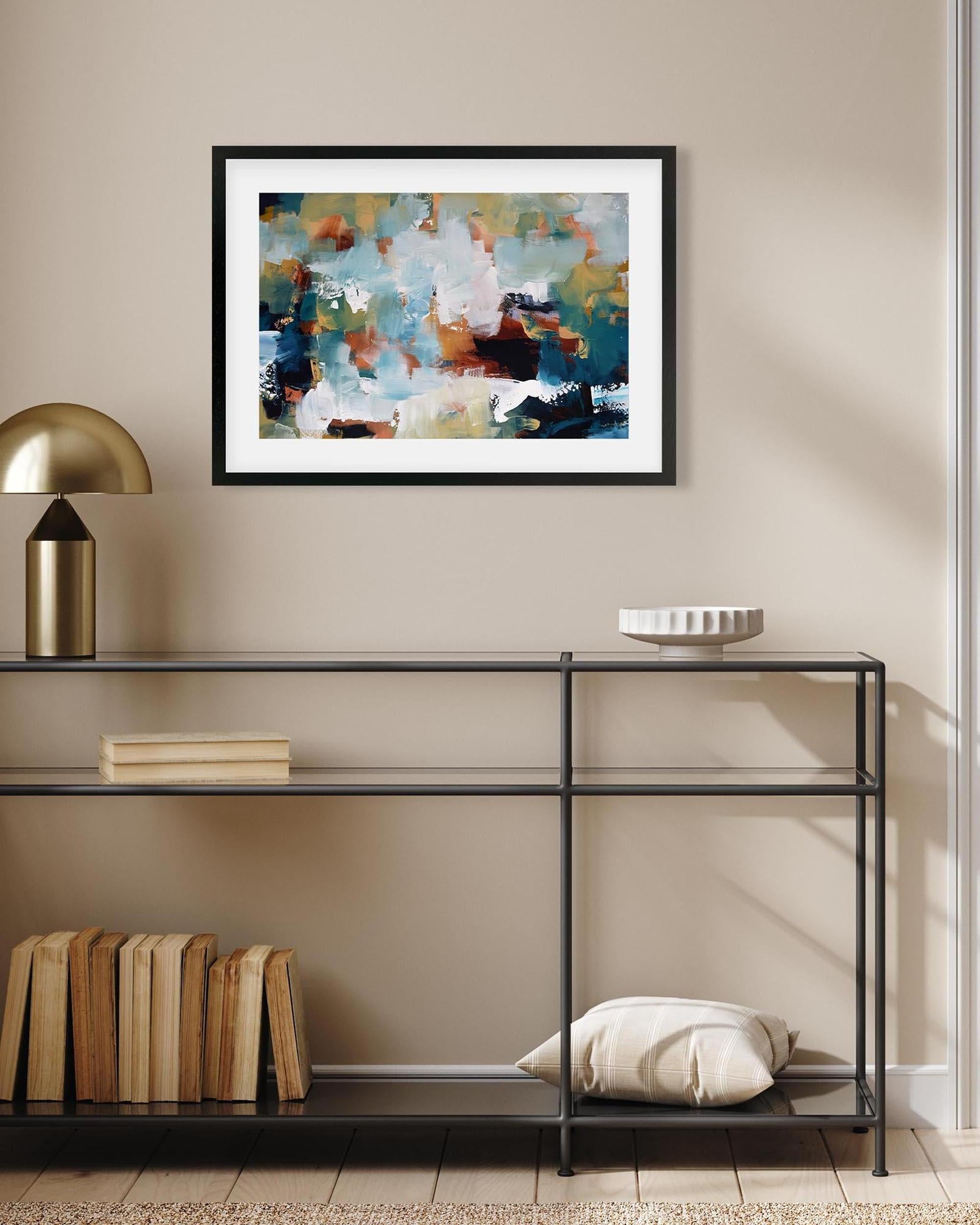 Framed abstract painting on a wall above a black metal console table with decorative items.