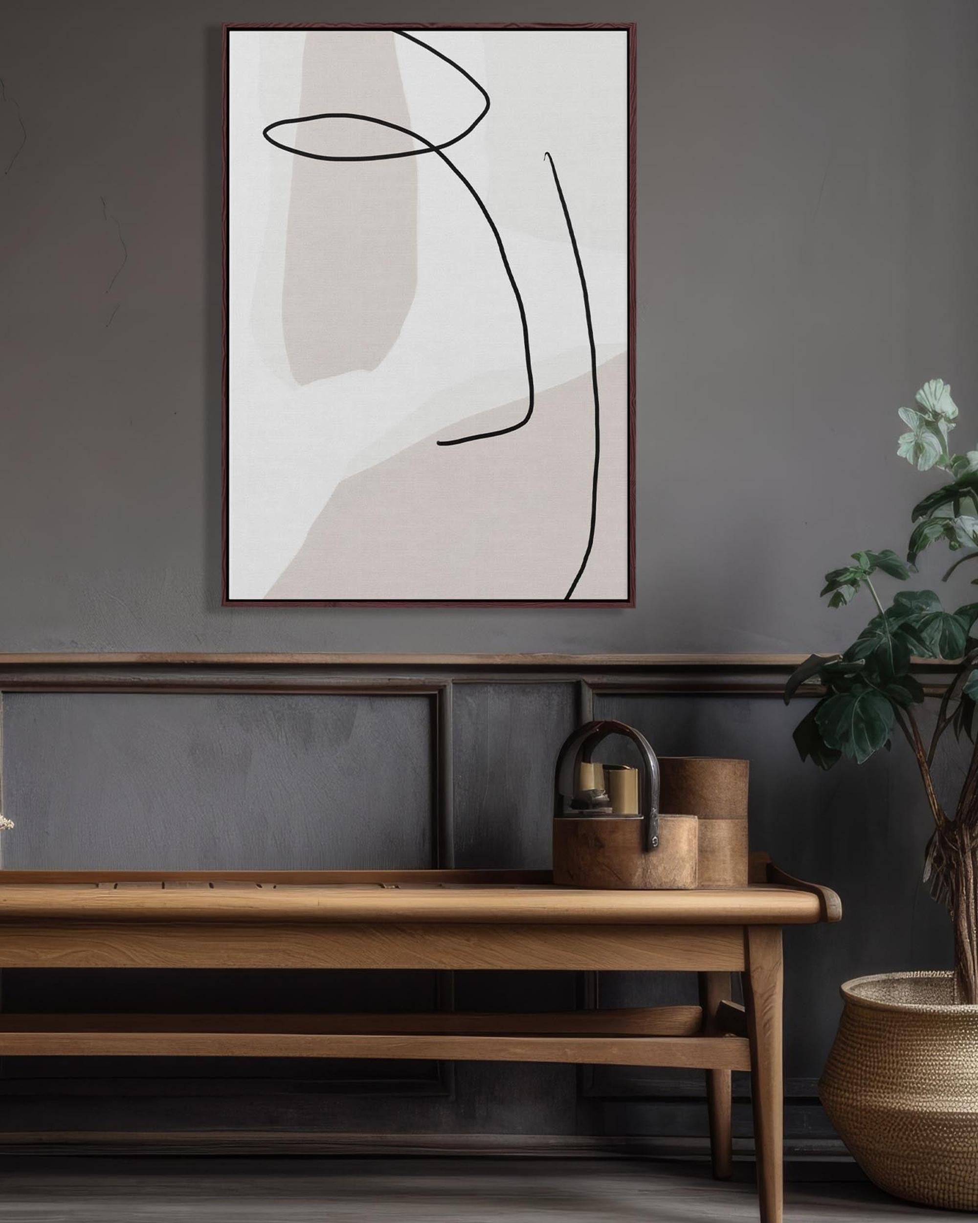 Abstract art piece on a wall above a wooden bench with a plant and decorative items.