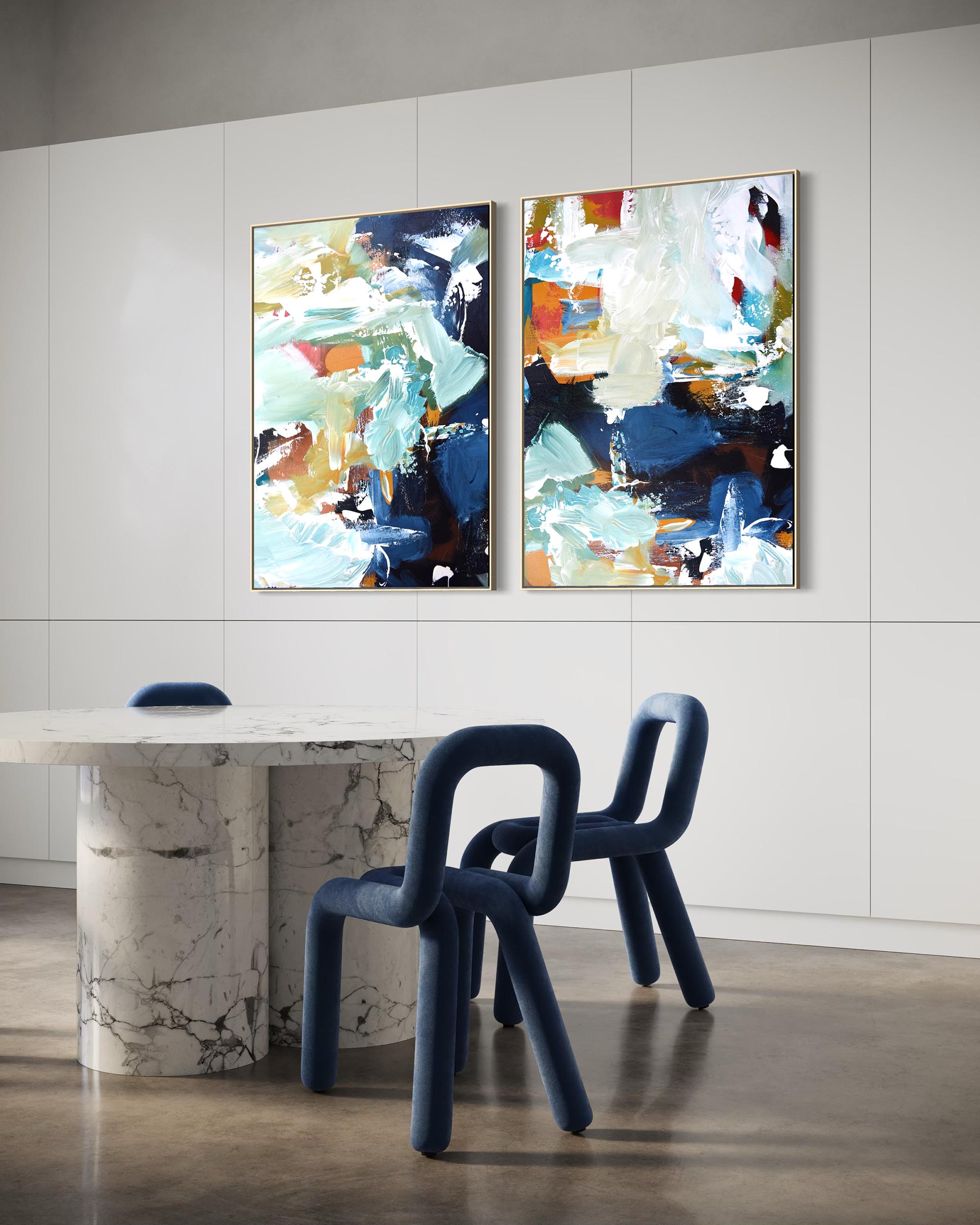 Two abstract paintings on a wall above a modern dining table and chairs.