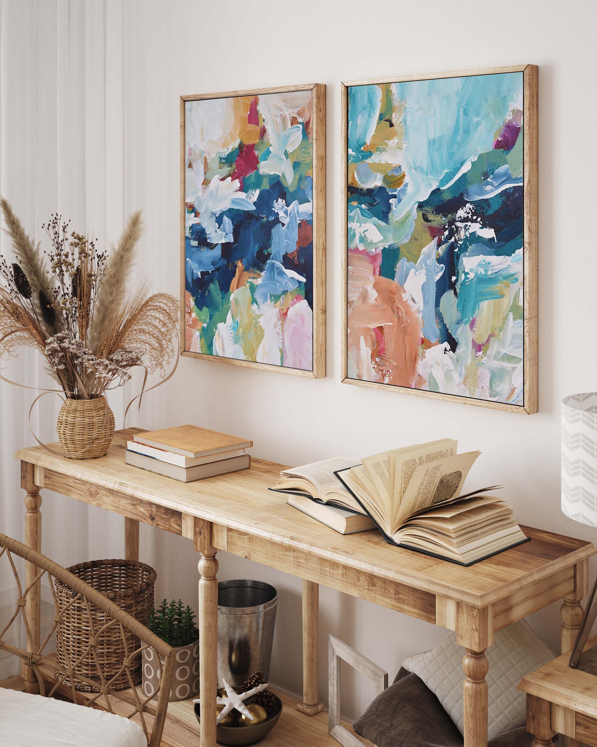 Wooden console table with books and a vase, featuring abstract art on the wall.