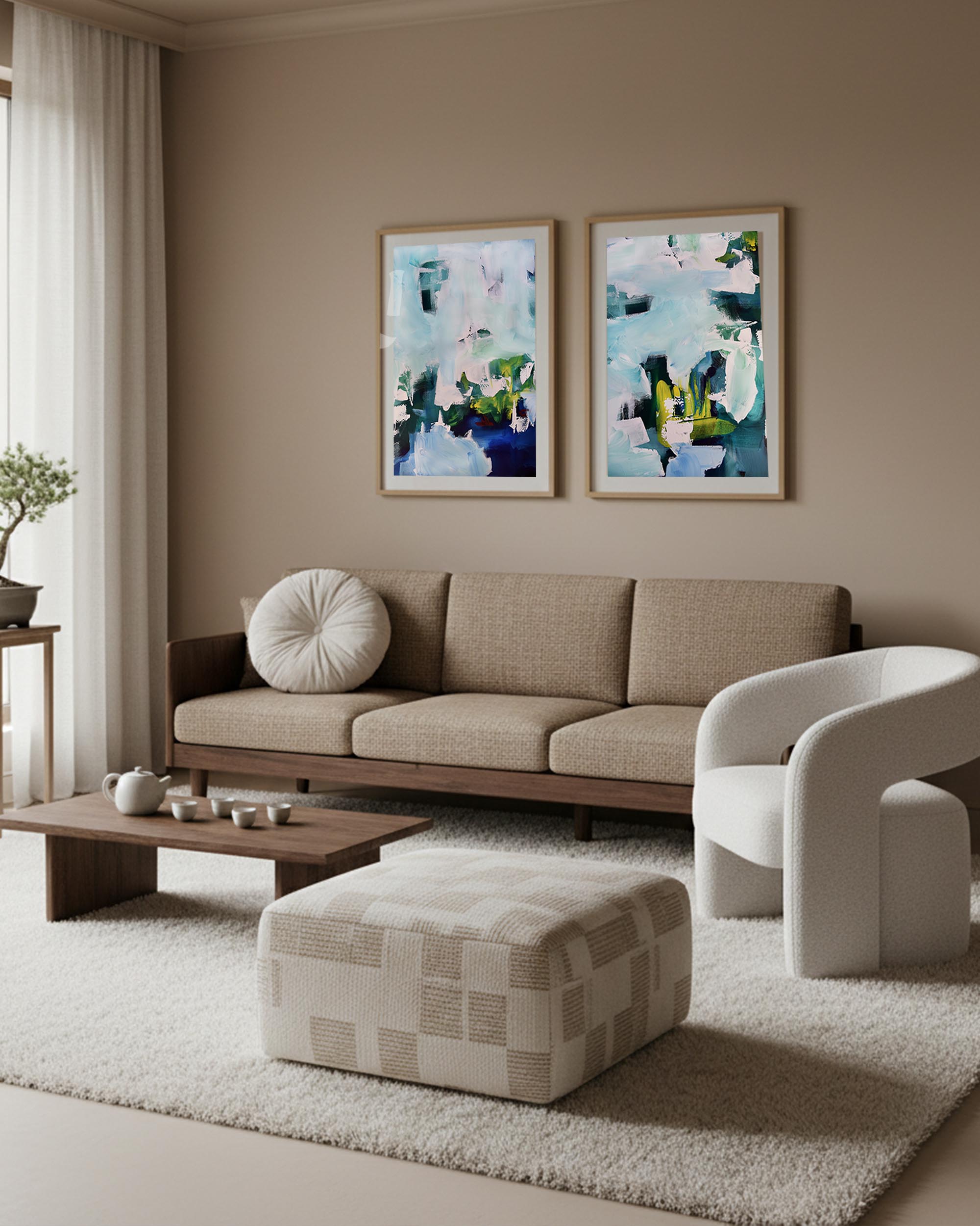 Modern living room with a beige sofa, white armchair, and abstract wall art.