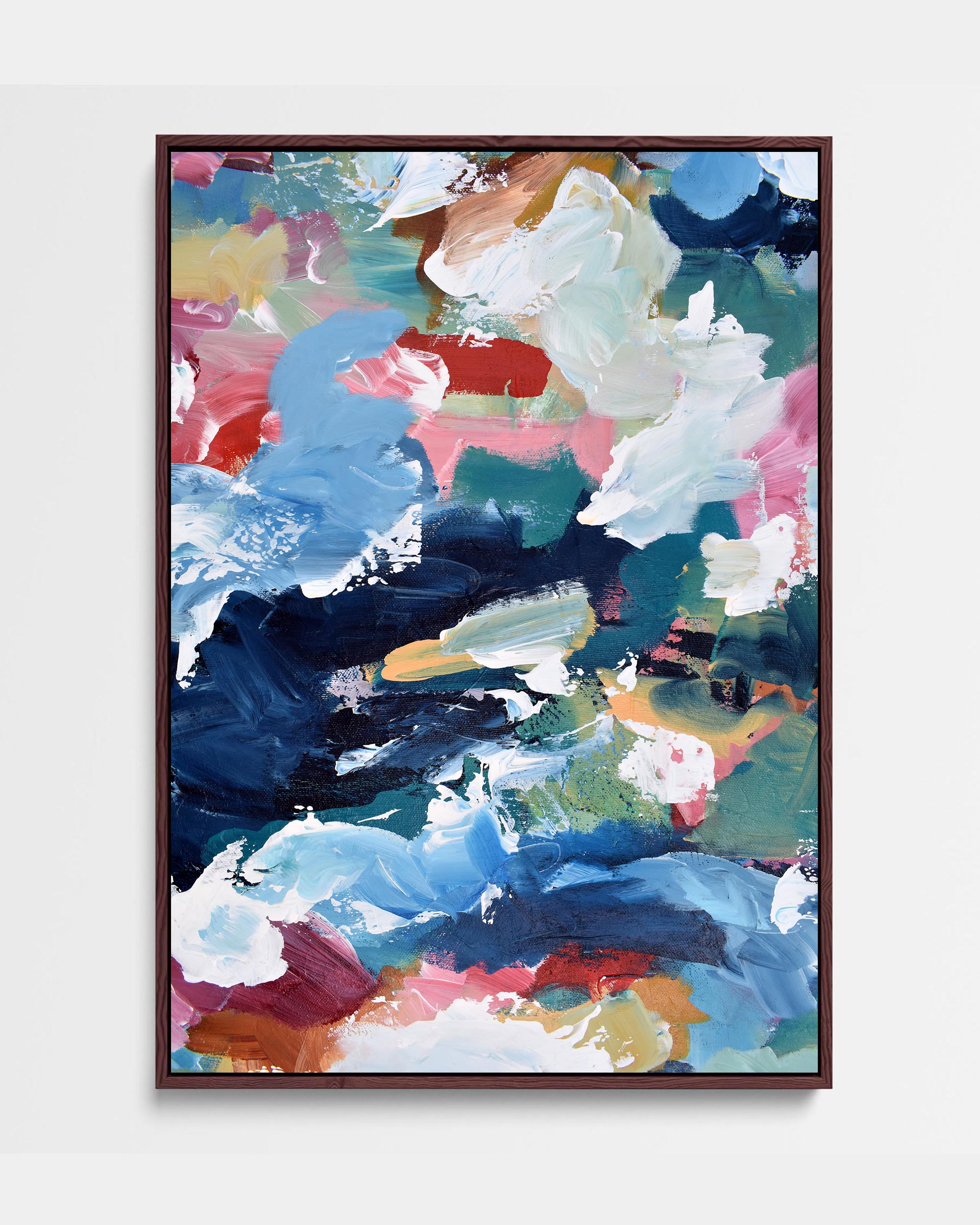 A vibrant abstract canvas painting with blue, red, pink, and brown tones, framed in a choice of black or white.