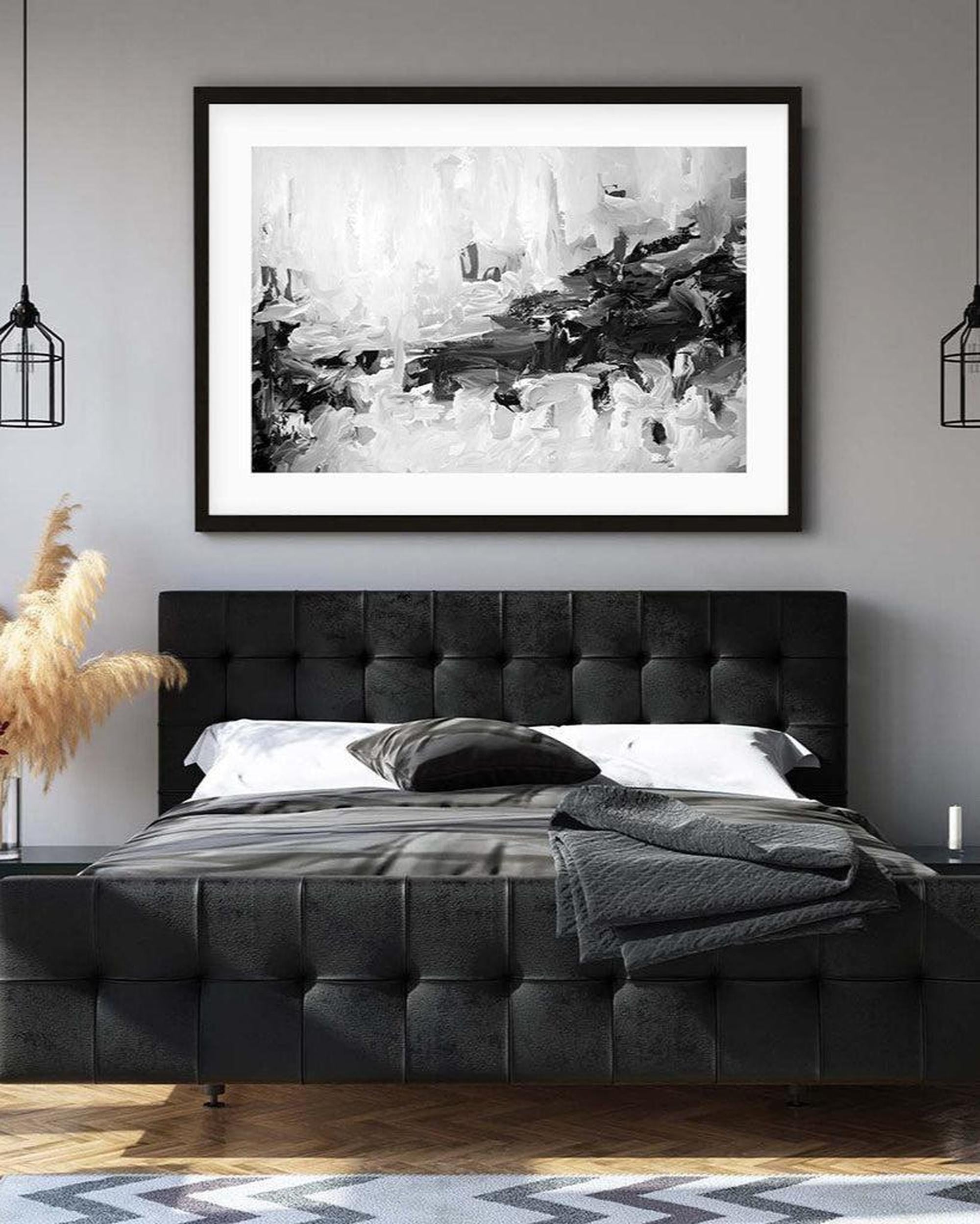 Modern bedroom with a black upholstered bed and abstract art on the wall.