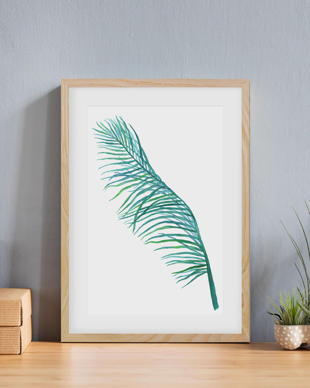 botanical art print frame in an oak frame on a table